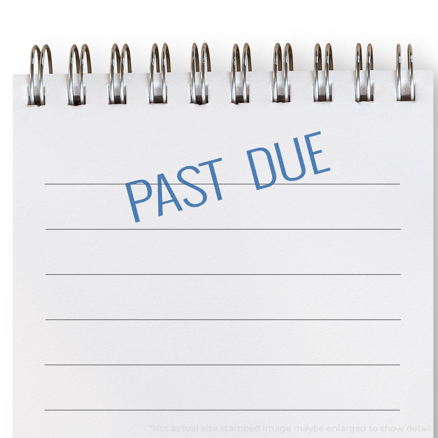 Blue Past Due Xstamper Stamp imprint on a white notepad with spiral binding, showing the words PAST DUE in blue ink.