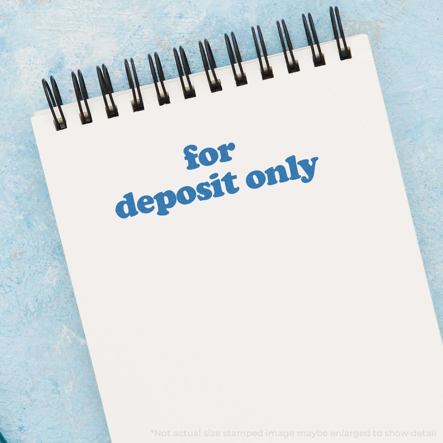 Slim Stamp 1444 Customized Pre-Inked Stamp 1/2 x 1-3/4 used on a notepad with the text for deposit only in blue ink.