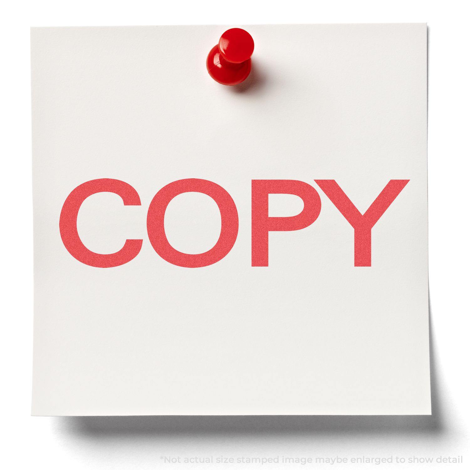 A white paper with COPY stamped in bold red using the Bold Red Copy Xstamper Stamp, pinned to a surface with a red pushpin.
