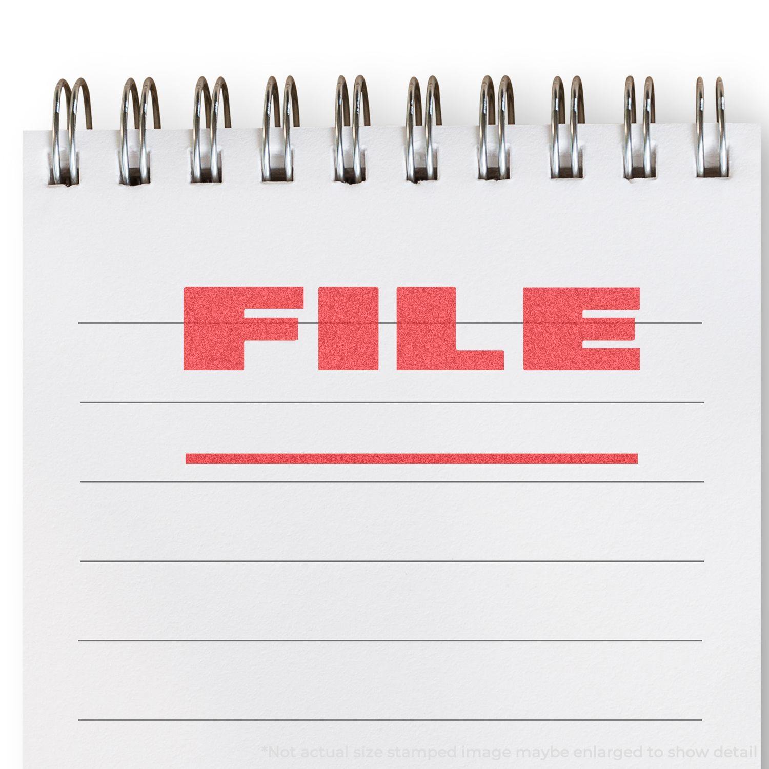 Bold Red File Xstamper Stamp marking "FILE" in red ink on a white spiral notebook page with lined paper.