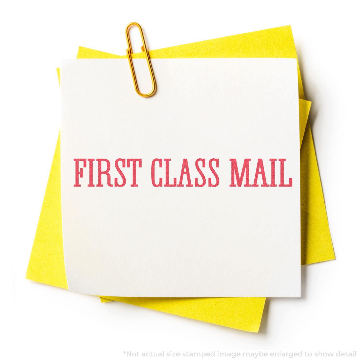 Bold Red First Class Mail Xstamper Stamp impression on white paper clipped to yellow sheets.