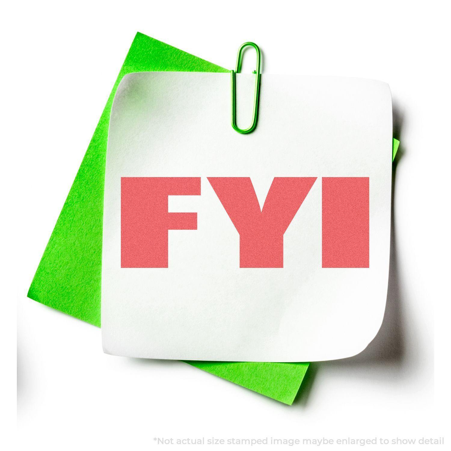 Bold Red FYI Xstamper Stamp impression on a white paper clipped to a green paper, showing the bold red FYI text.