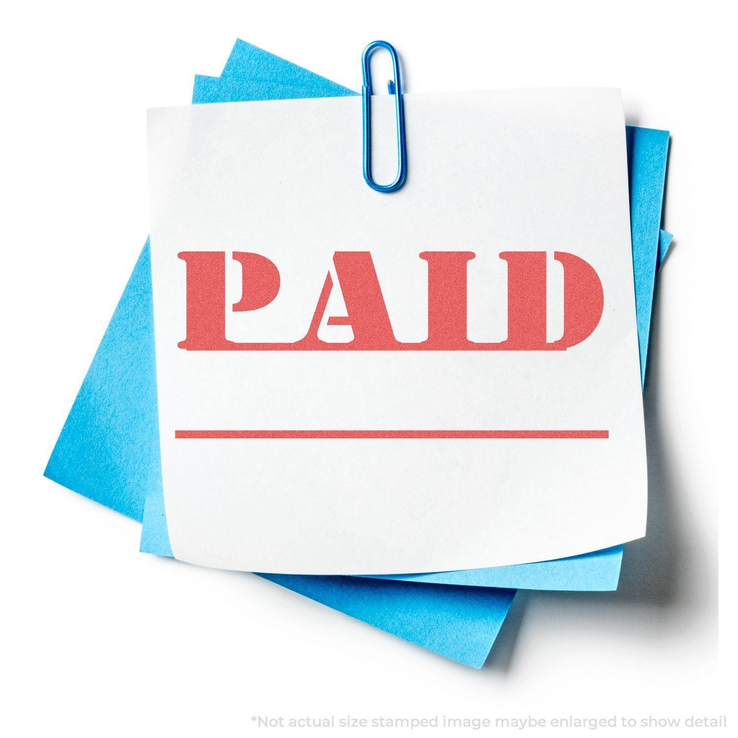 Bold Red Paid Xstamper Stamp impression on white paper, clipped to blue sheets with a paperclip.