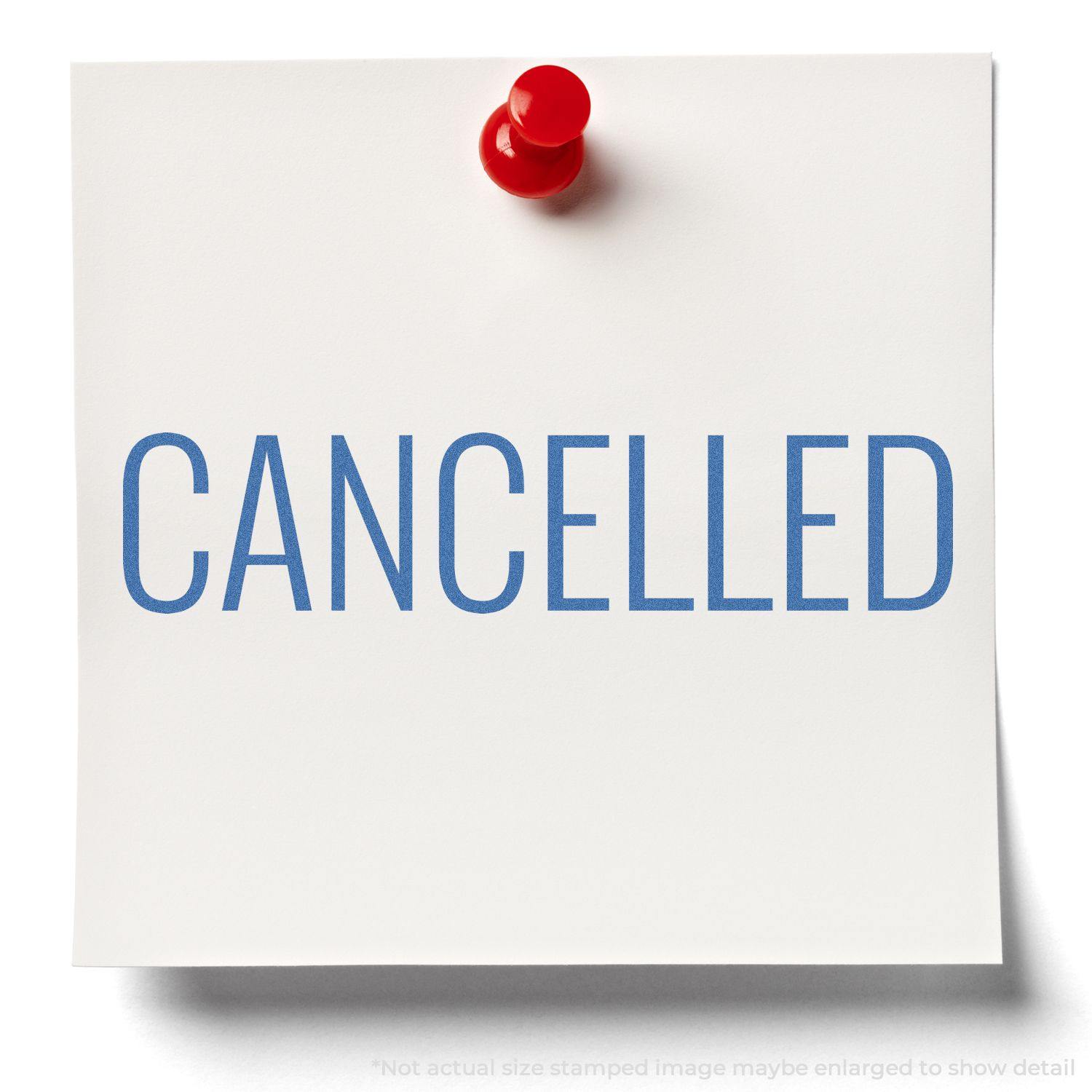 A white note pinned with a red pushpin stamped with CANCELLED in blue ink using the Cancelled Xstamper Stamp.