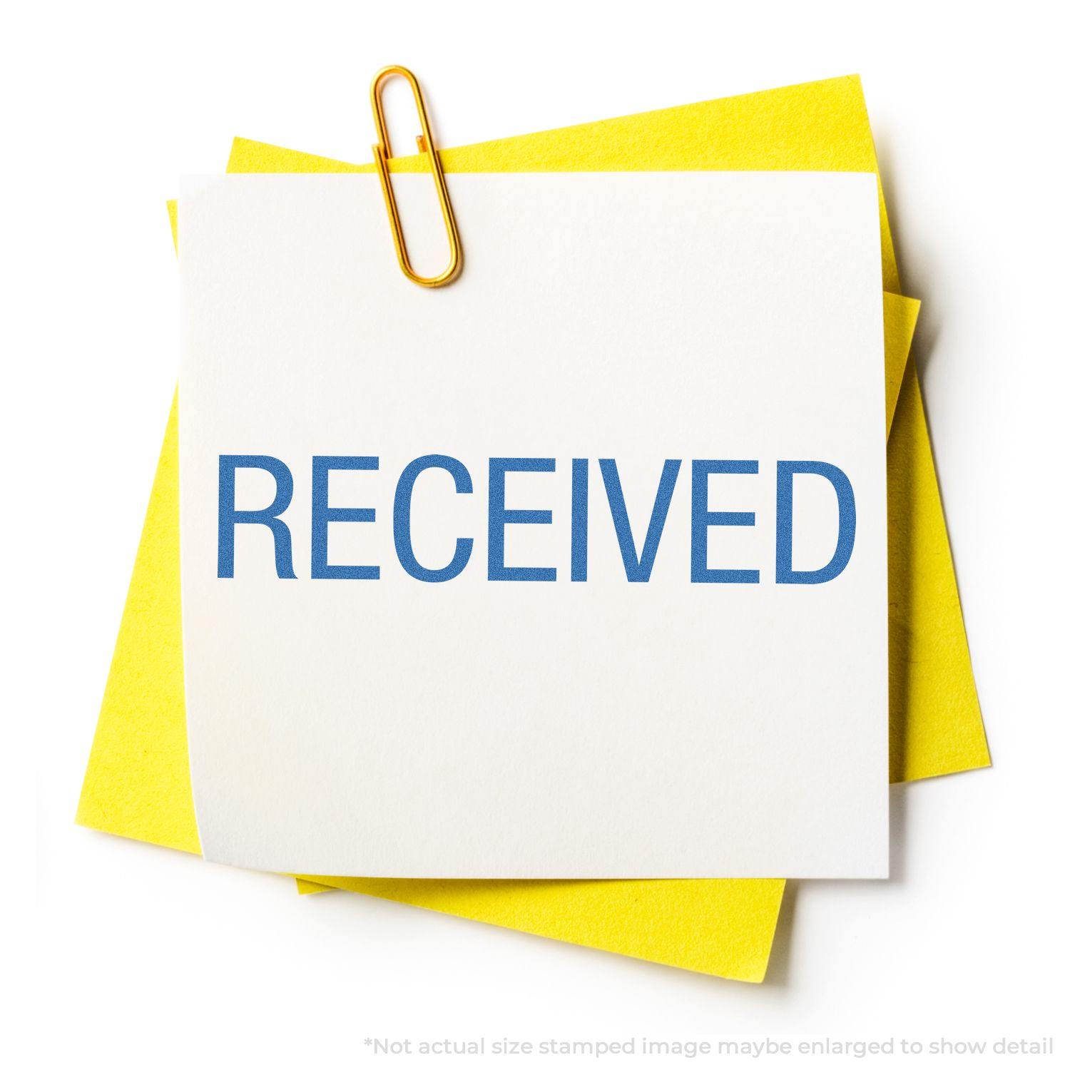 Dark Blue Received Xstamper Stamp marking RECEIVED on white paper with yellow background, held by a gold paperclip.
