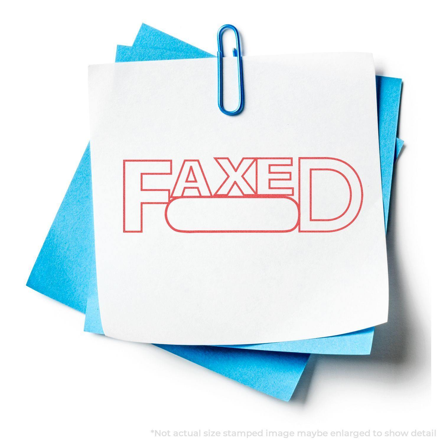Date Faxed Xstamper Stamp imprint on white paper with blue sheets underneath, held together by a blue paperclip.