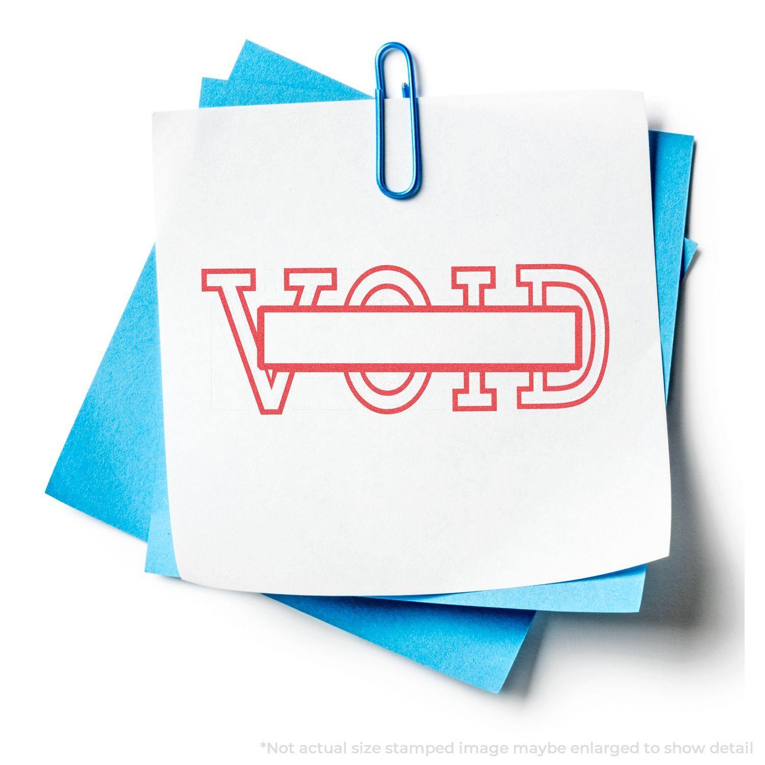 A Date Void Xstamper Stamp imprint on white paper with VOID in red letters, clipped to blue sheets with a blue paperclip.