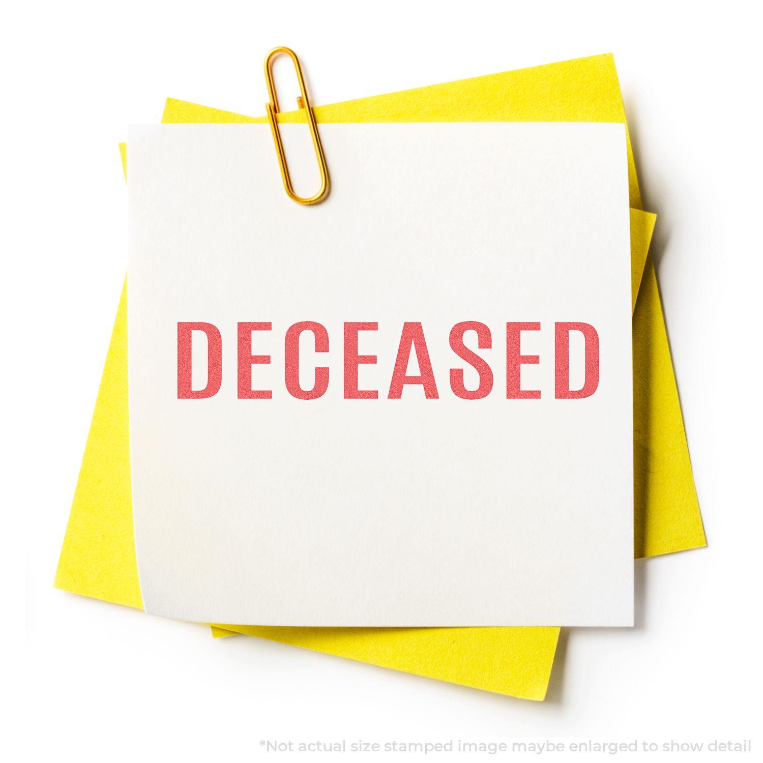 Deceased Xstamper Stamp imprint on a white paper with a yellow paper underneath, held together by a paperclip.