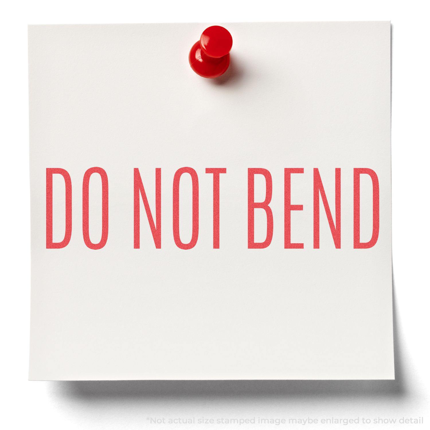A red DO NOT BEND message stamped on a white paper with a red pushpin, created using the Do Not Bend Xstamper Stamp.