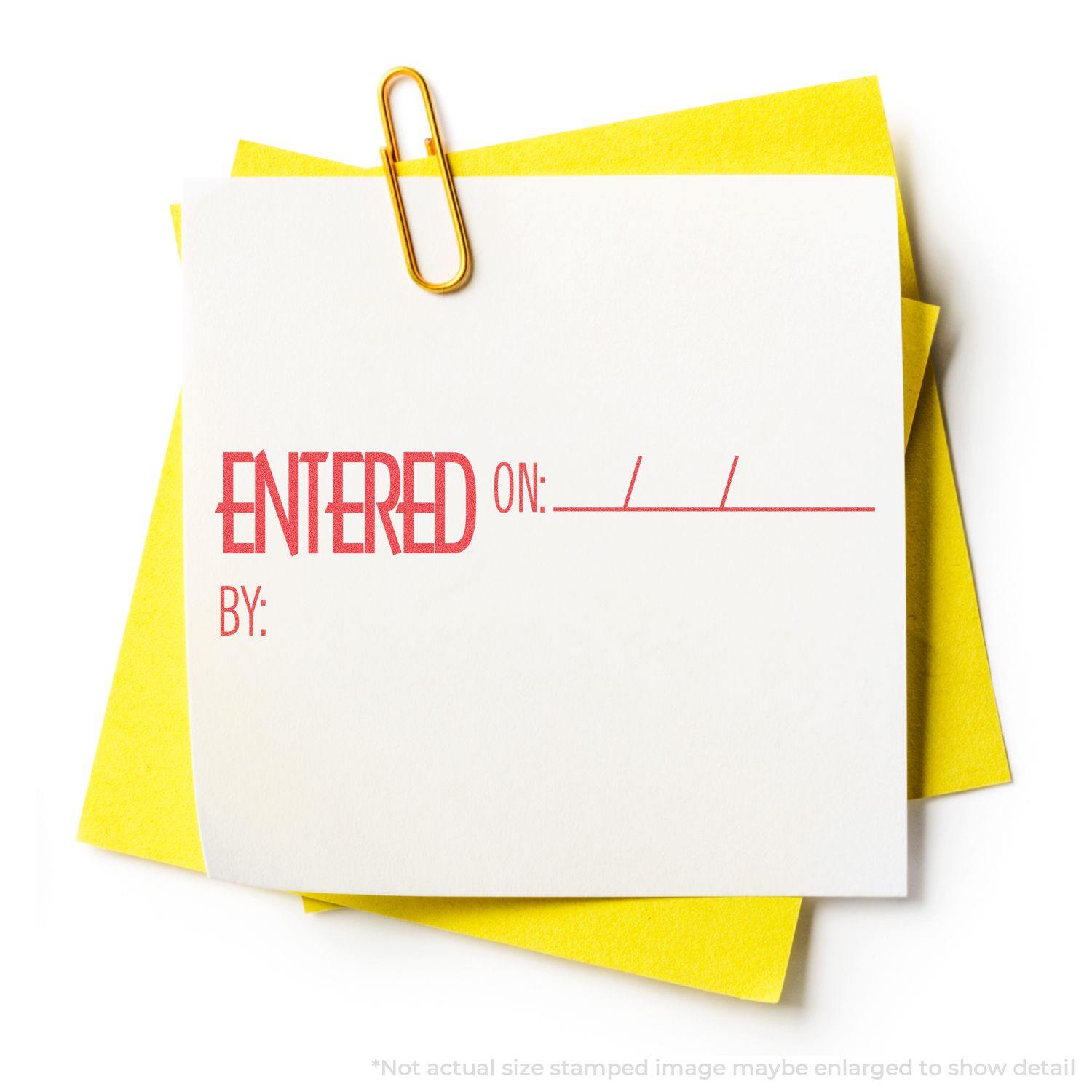 A yellow paperclip holds white and yellow papers stamped with ENTERED ON: / / BY: in red ink using an Xstamper Stamp.