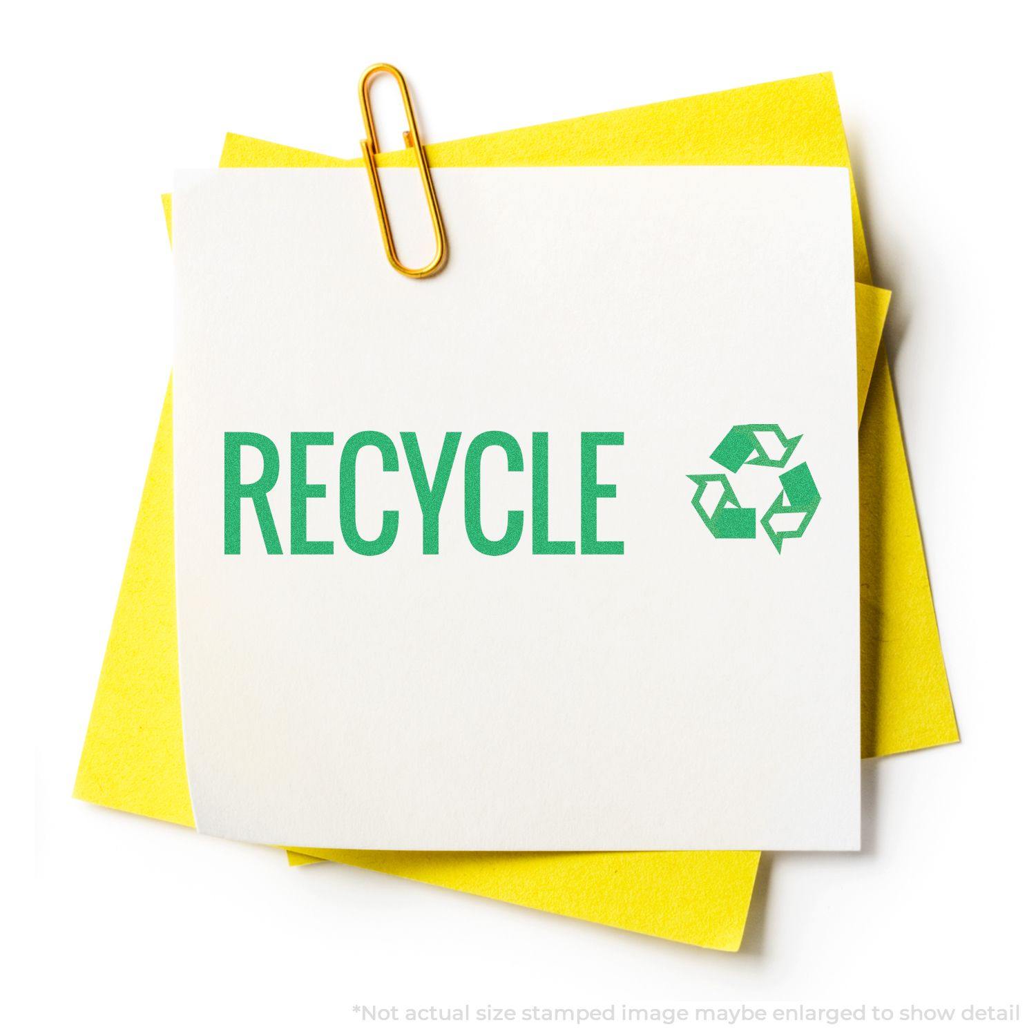 Green Recycle Xstamper Stamp imprint on white paper with a yellow background, featuring the word RECYCLE and a recycling symbol in green.