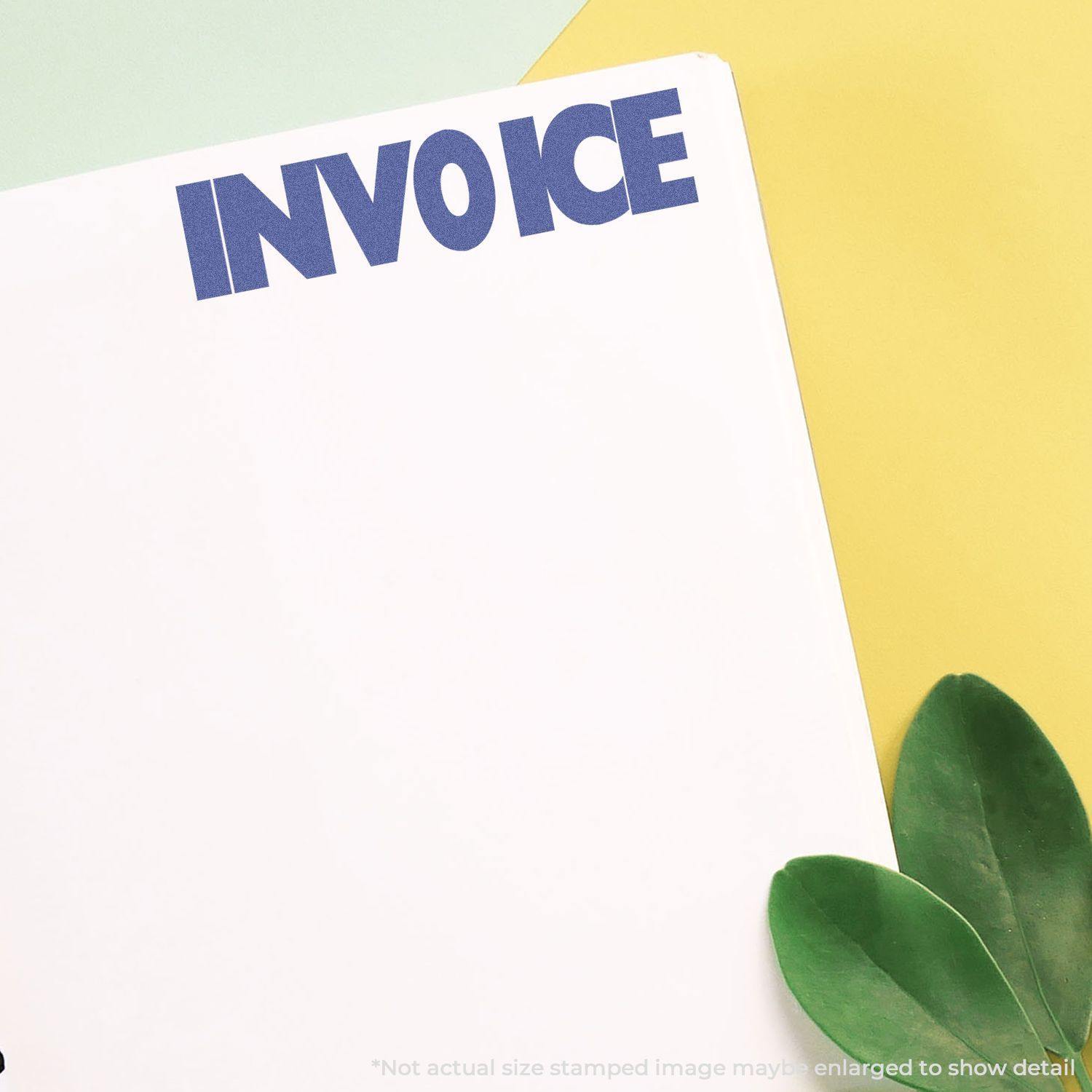 Invoice Xstamper Stamp marking the word INVOICE in bold blue letters on a white sheet, placed on a colorful background with green leaves.