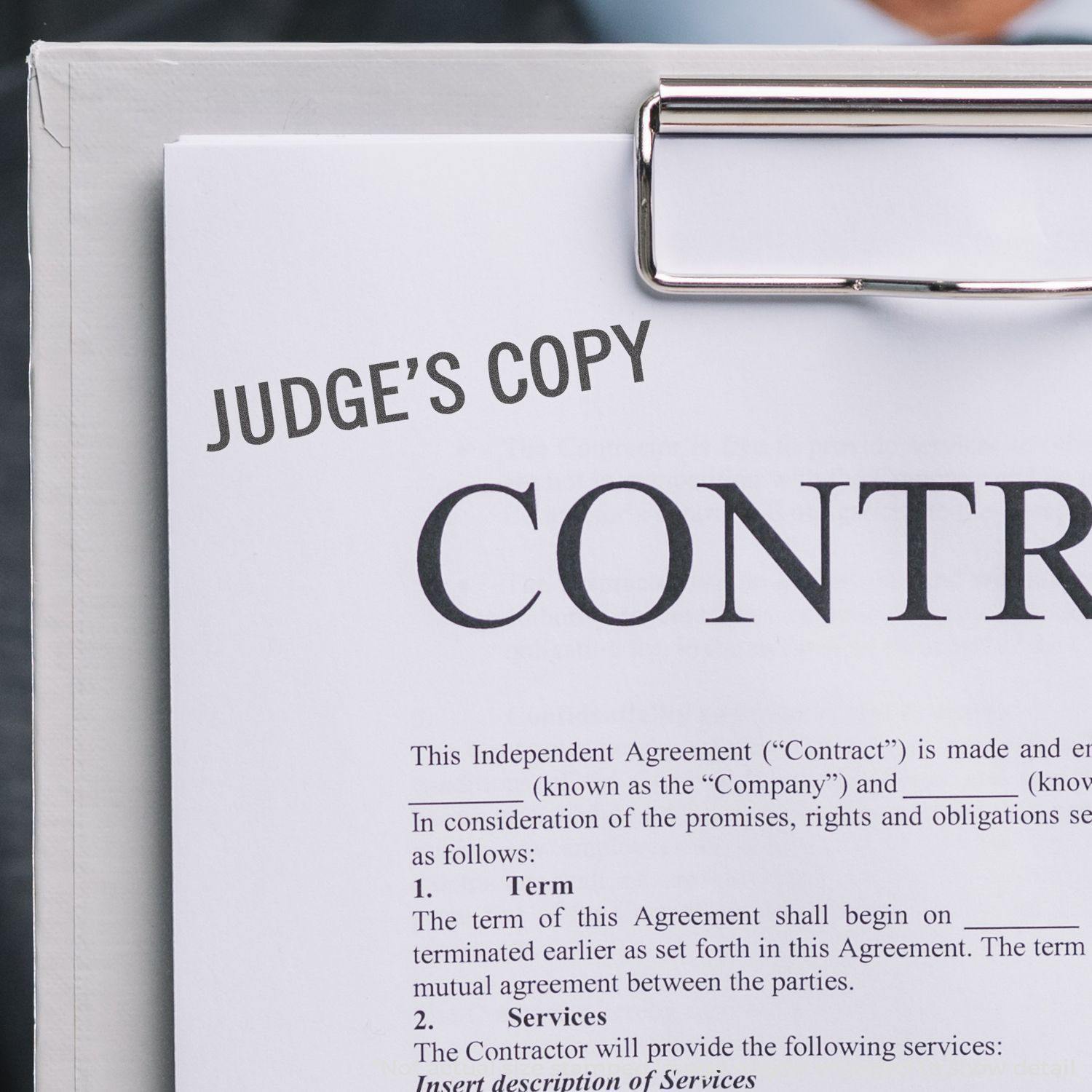 Close-up of a clipboard with a document stamped JUDGE'S COPY using the Judge's Copy Xstamper Stamp.