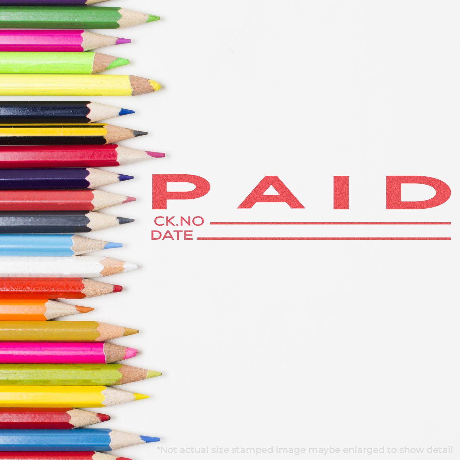 Colorful pencils beside a stamped PAID mark with CK.NO and DATE lines using the Jumbo Paid Ck No.-Date Xstamper Stamp.