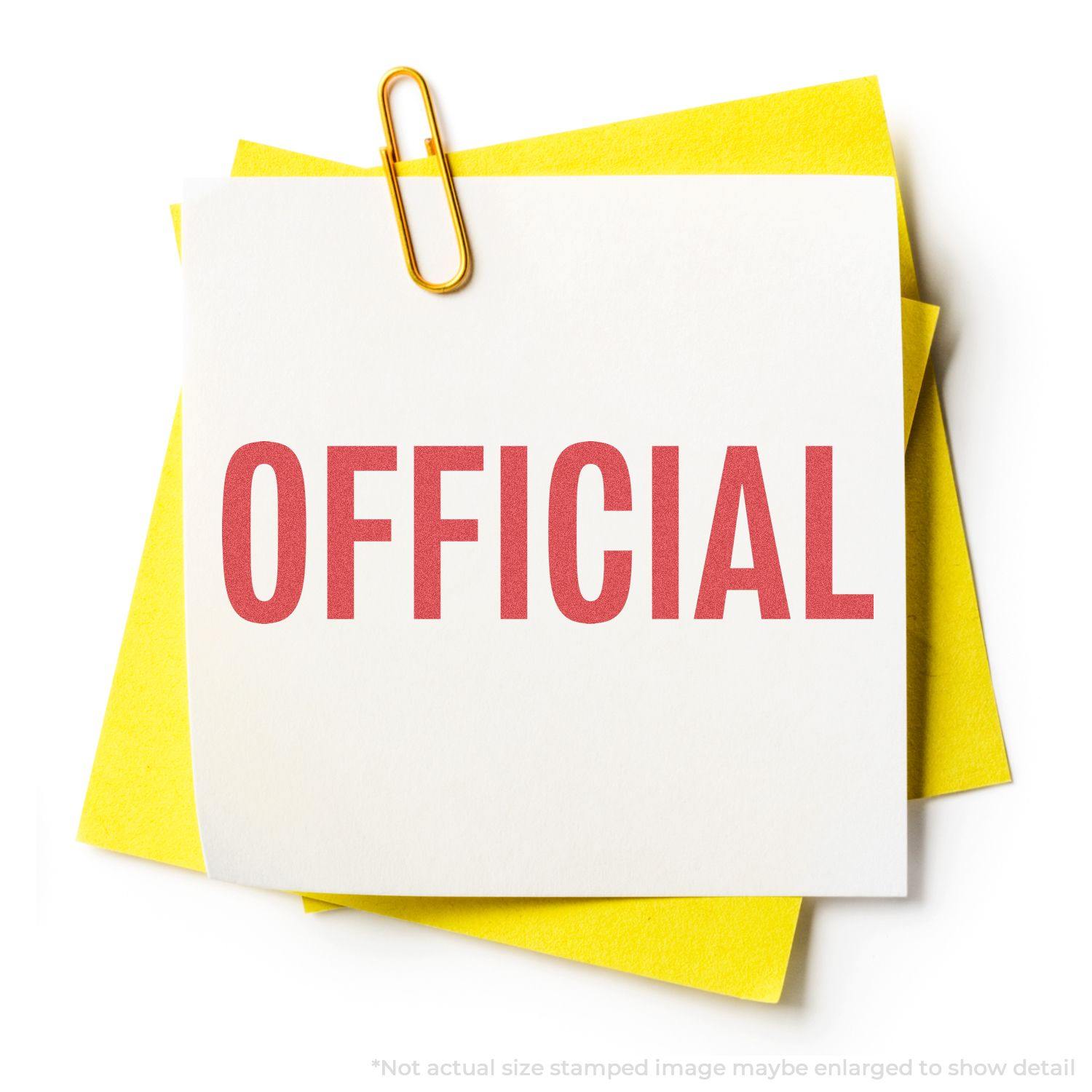 A white paper with OFFICIAL stamped in red using the Official Xstamper Stamp, clipped to yellow papers with a gold paperclip.