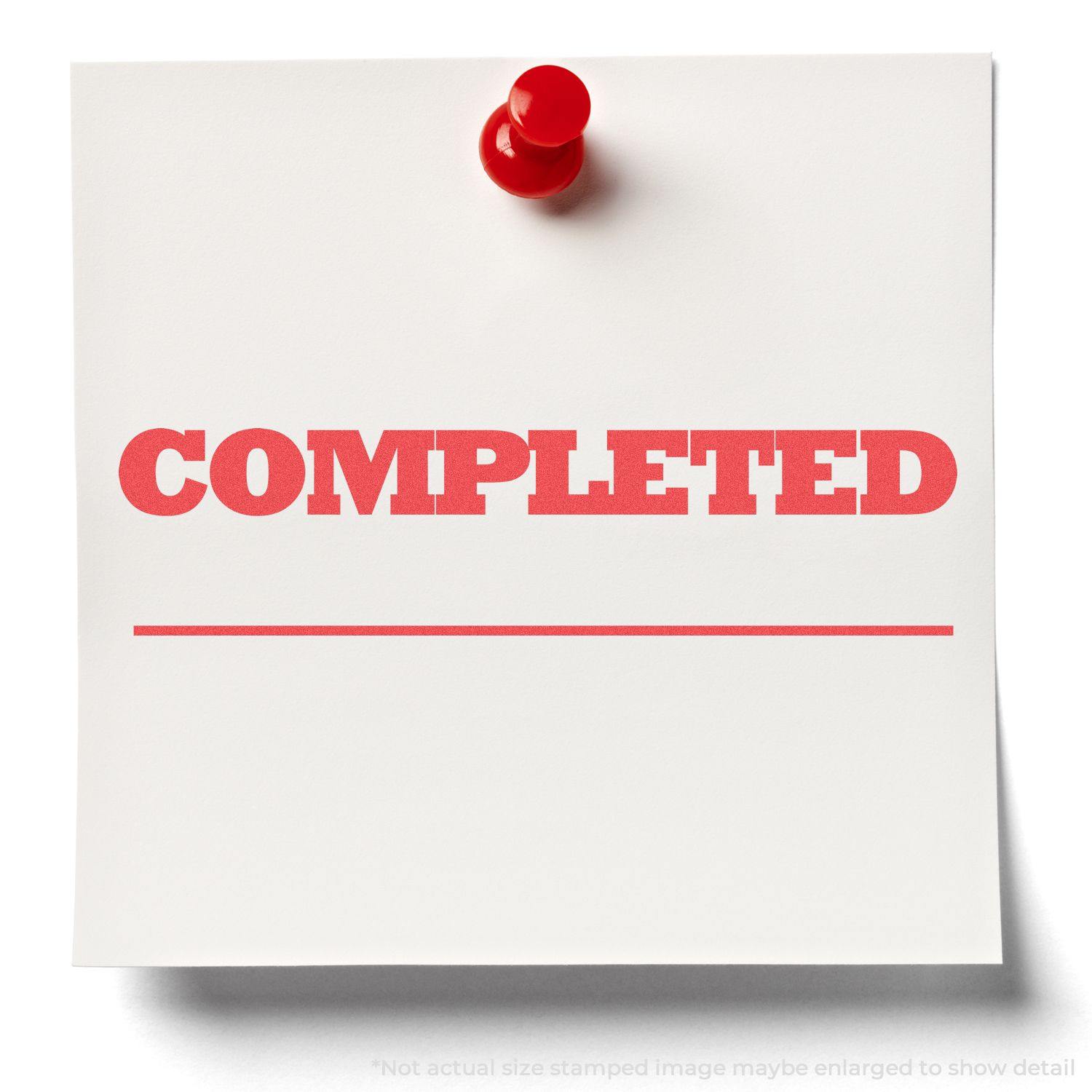 Red Completed Xstamper Stamp imprint on a white paper pinned to a board with a red pushpin.
