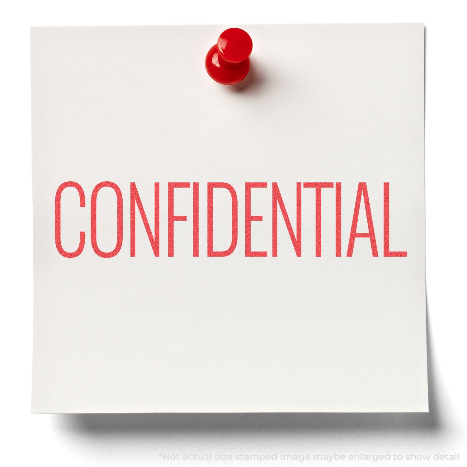 Red Confidential Xstamper Stamp imprint on a white paper pinned with a red pushpin.