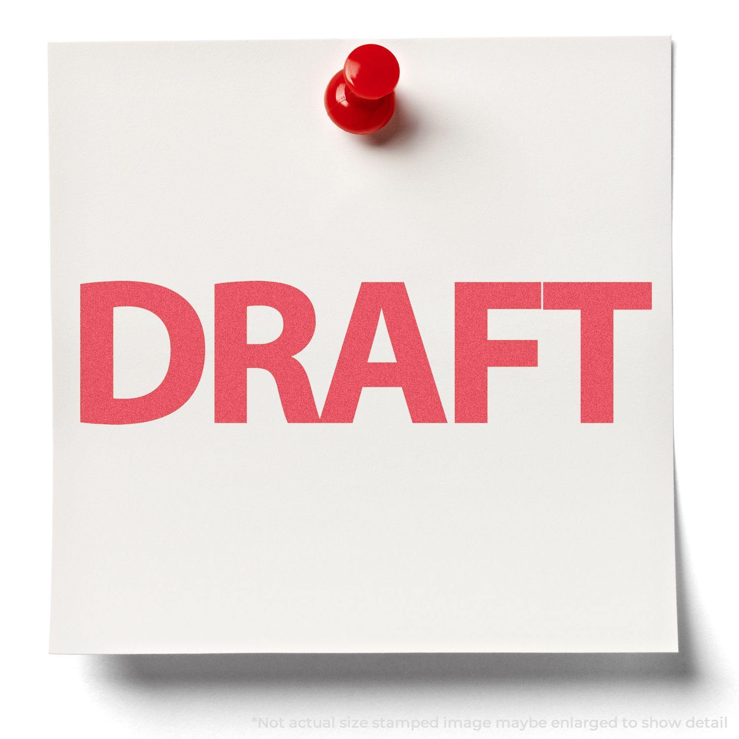 Red Draft Xstamper Stamp imprint on white paper pinned to a board with a red pushpin.