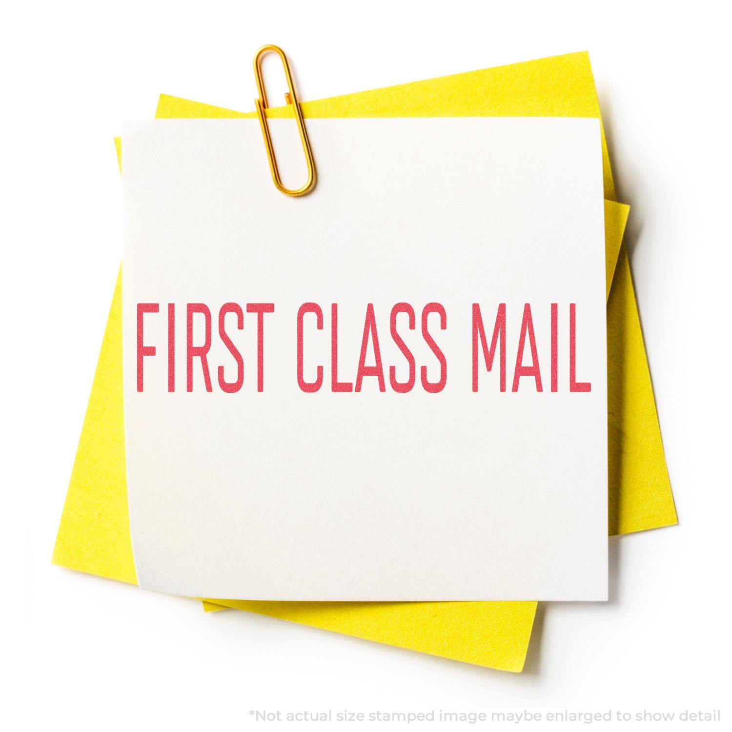 Red First Class Mail Xstamper Stamp imprint on white paper clipped to yellow sheets, showcasing clear, bold red text.