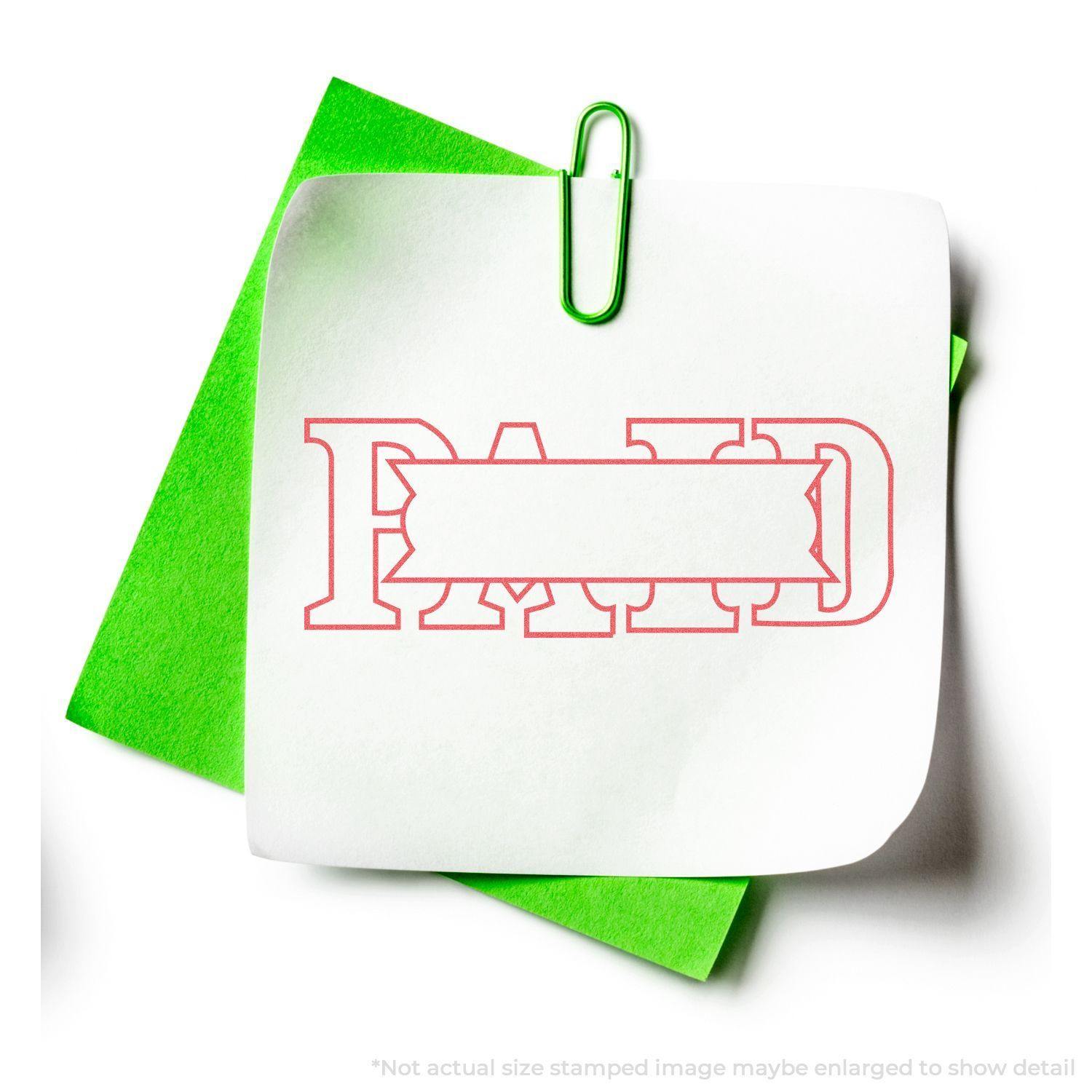 Red Paid Xstamper Stamp imprint on white paper with green paperclip and green paper background.