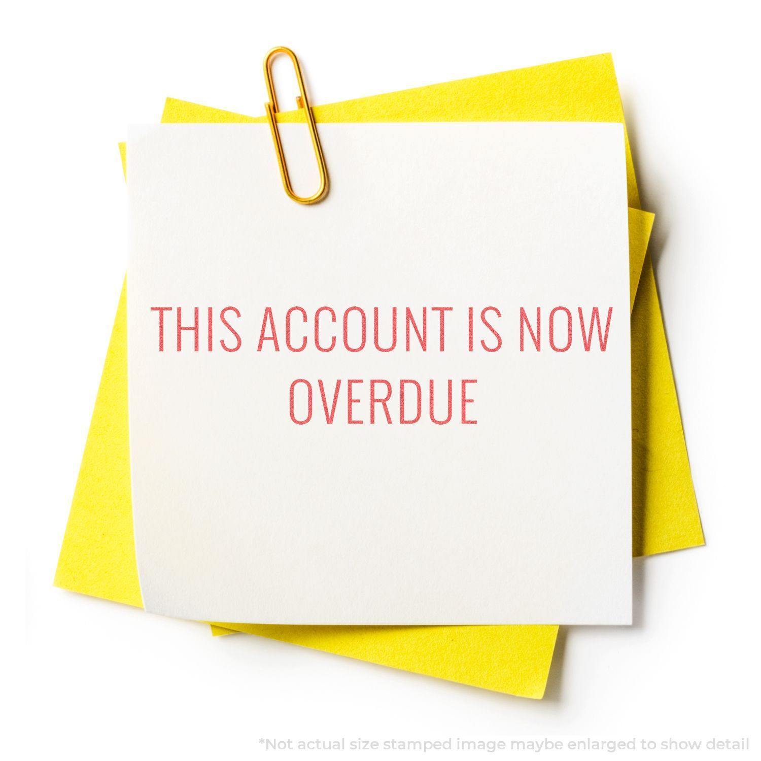 A white paper stamped with THIS ACCOUNT IS NOW OVERDUE in red using the Red This Account Is Now Overdue Xstamper Stamp, clipped to yellow papers.