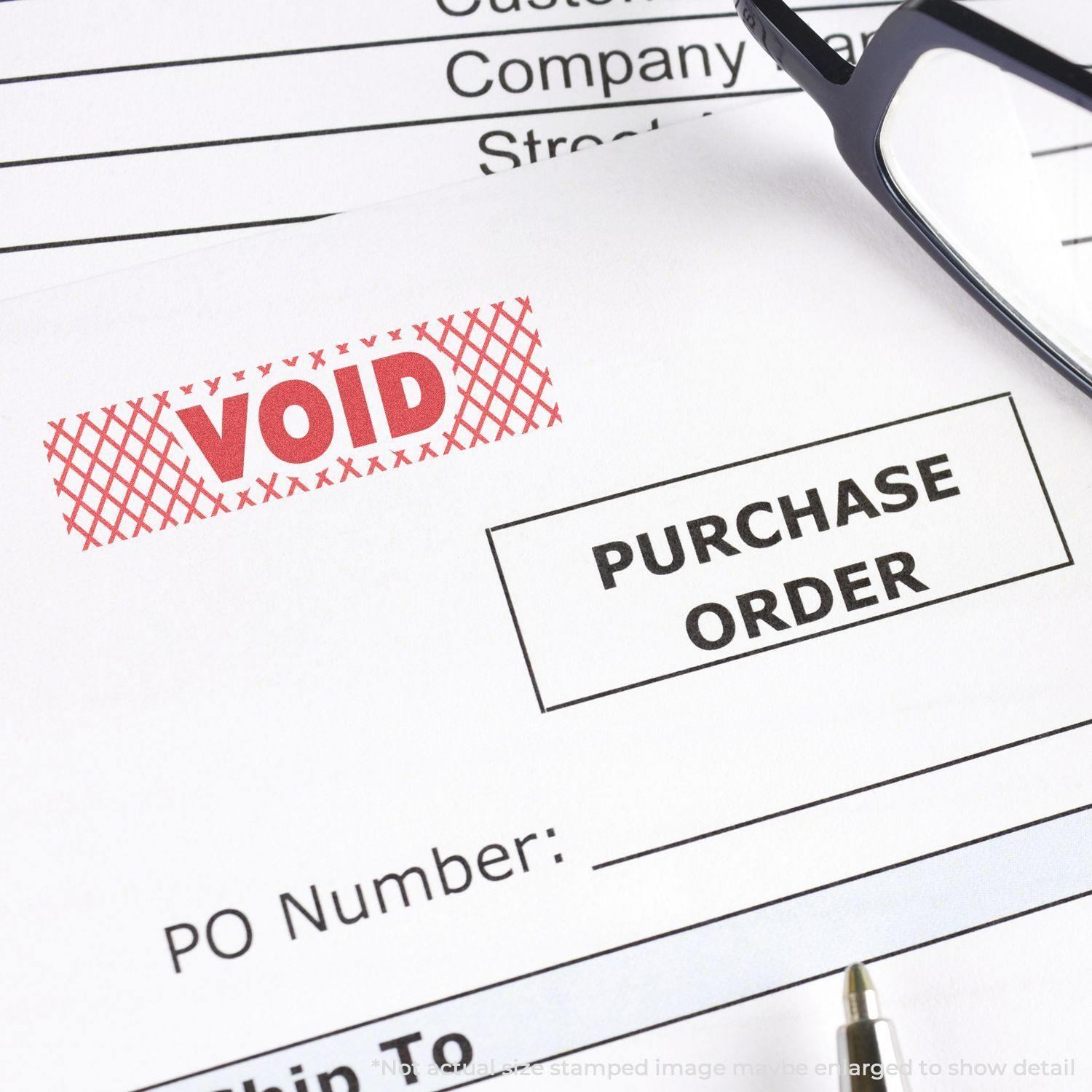 Red Void Xstamper Stamp marking VOID on a purchase order document, with glasses and a pen nearby.