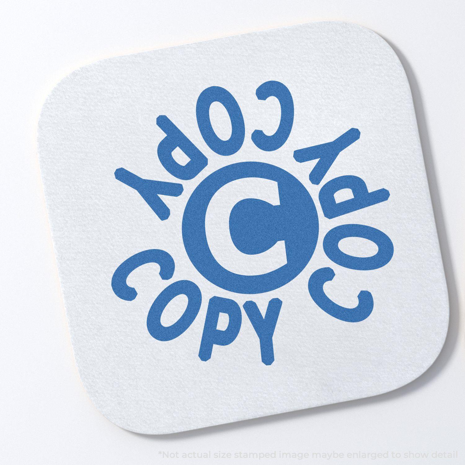 Round Blue Copy Xstamper Stamp imprint on white paper, showing the word COPY in blue text arranged in a circular pattern around a central C .