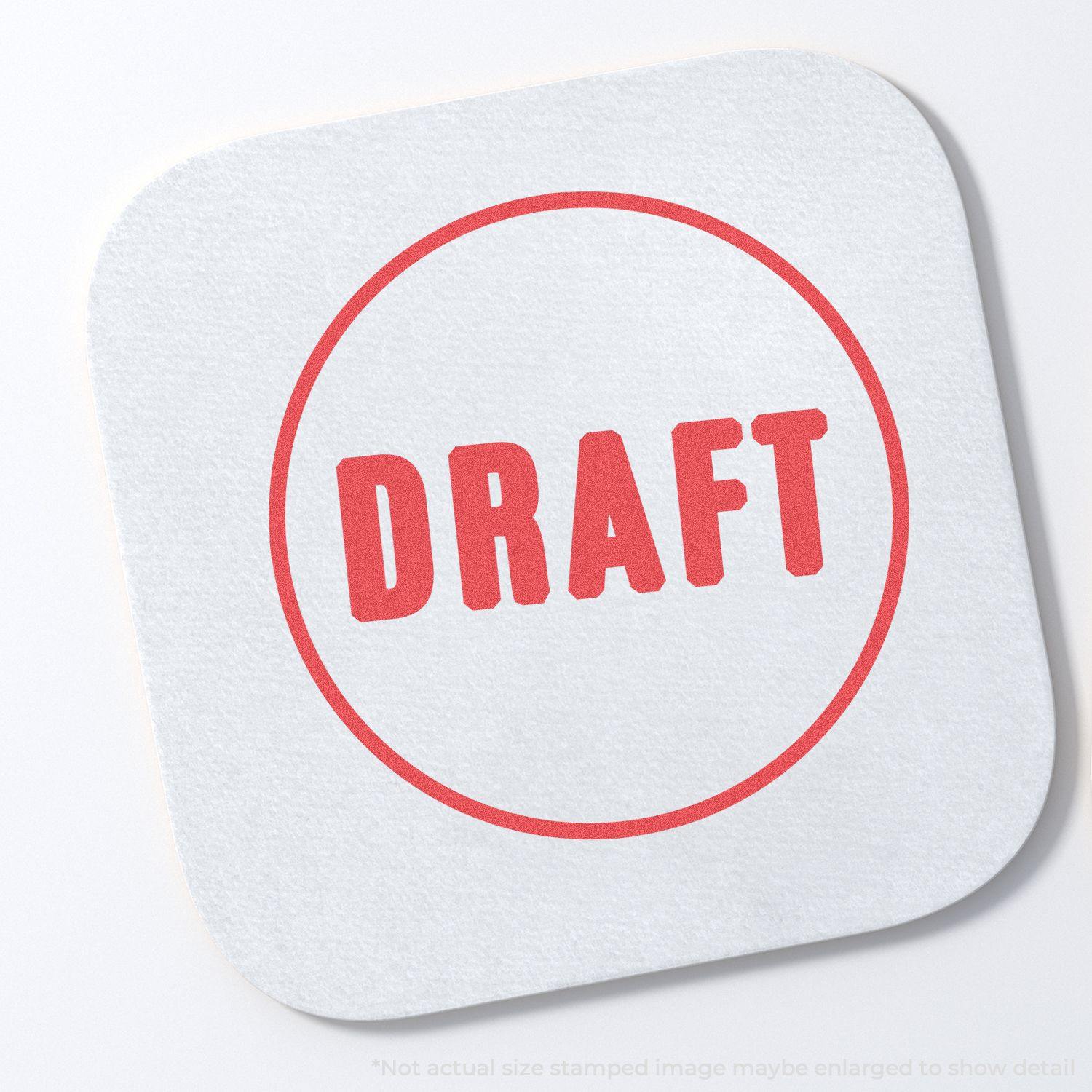 Round Draft Xstamper Stamp imprint in red on a white square paper, displaying the word DRAFT in bold letters within a circle.