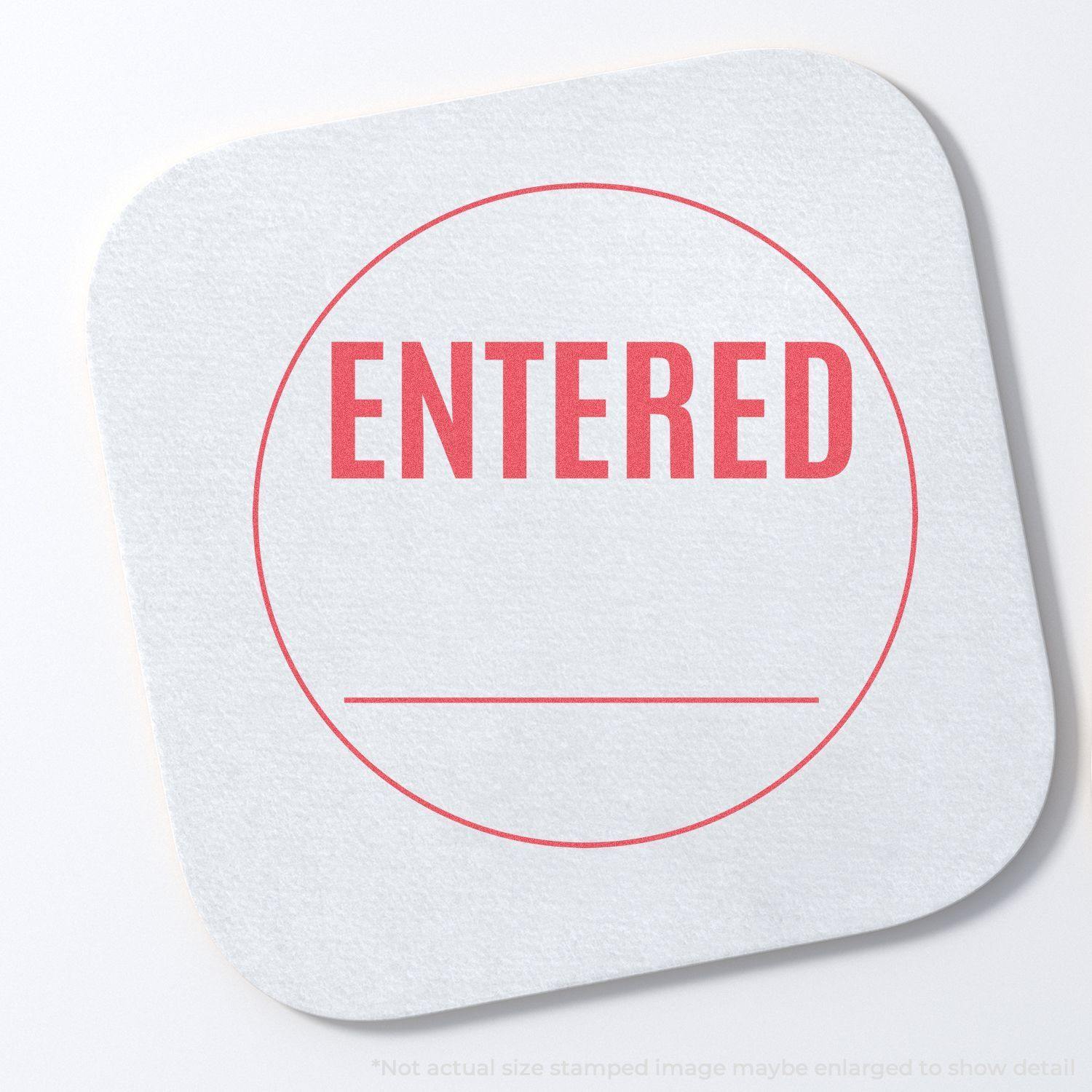 Round Entered Xstamper Stamp imprint on a white square paper, showing the word ENTERED in red within a circle.