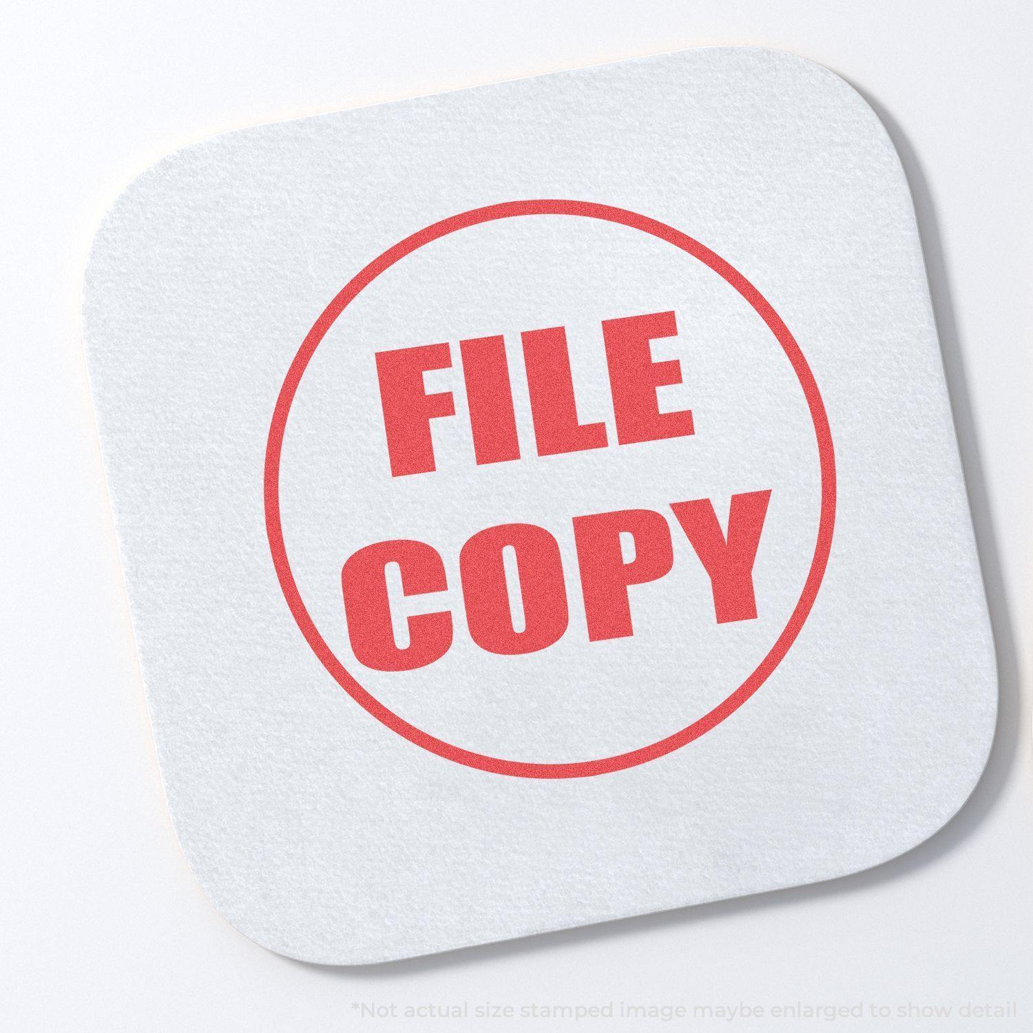Round File Copy Xstamper Stamp imprint in red ink on a white square paper with rounded corners, displaying the words FILE COPY in bold letters.