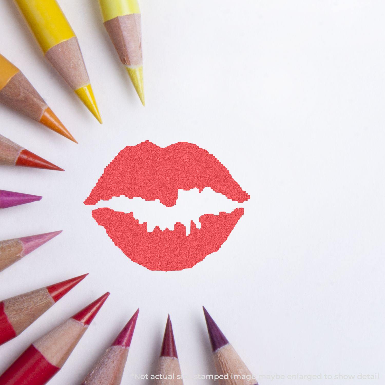 Round Kiss Xstamper Stamp imprint of red lips on white paper, surrounded by colored pencils arranged in a circular pattern.