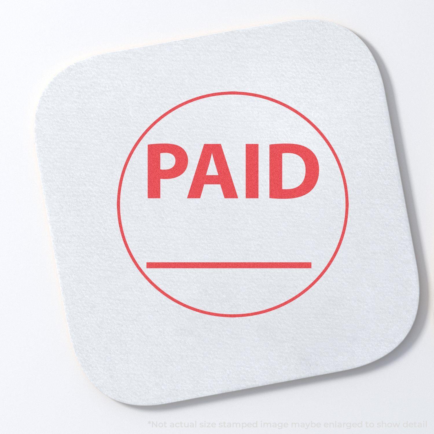 Round Paid Xstamper Stamp imprint on white paper, showing a red PAID text inside a circle with a line underneath.