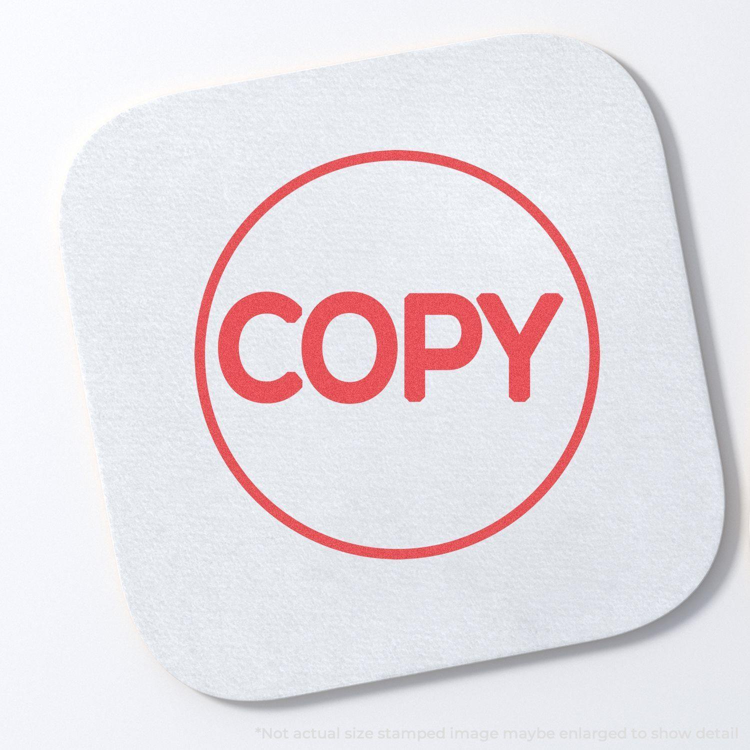 Round Red Copy Xstamper Stamp imprint on a white square paper, showing the word COPY in bold red letters inside a circle.