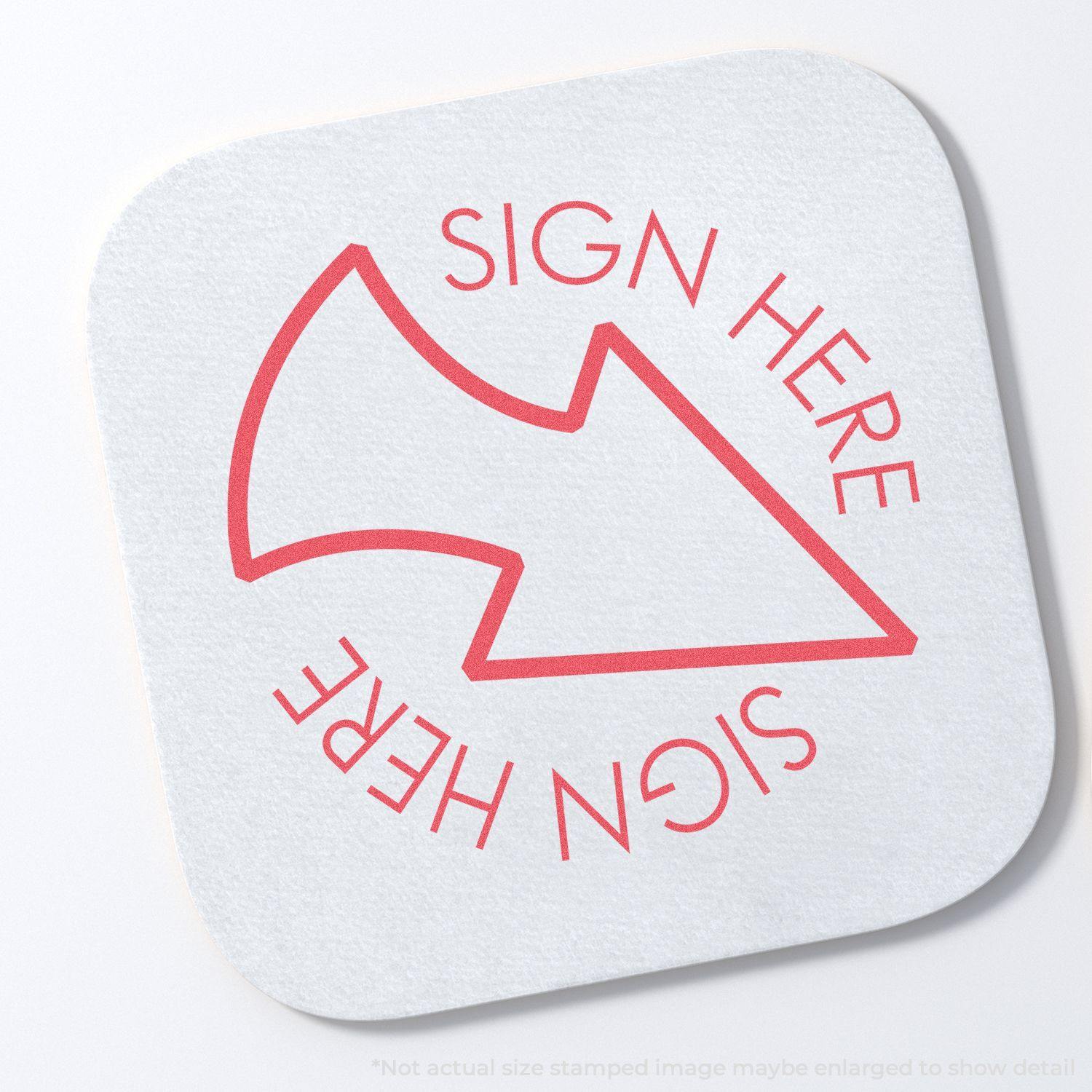 Round Red Sign Here Xstamper Stamp imprint on white paper, featuring a red arrow pointing left with SIGN HERE text above and below the arrow.
