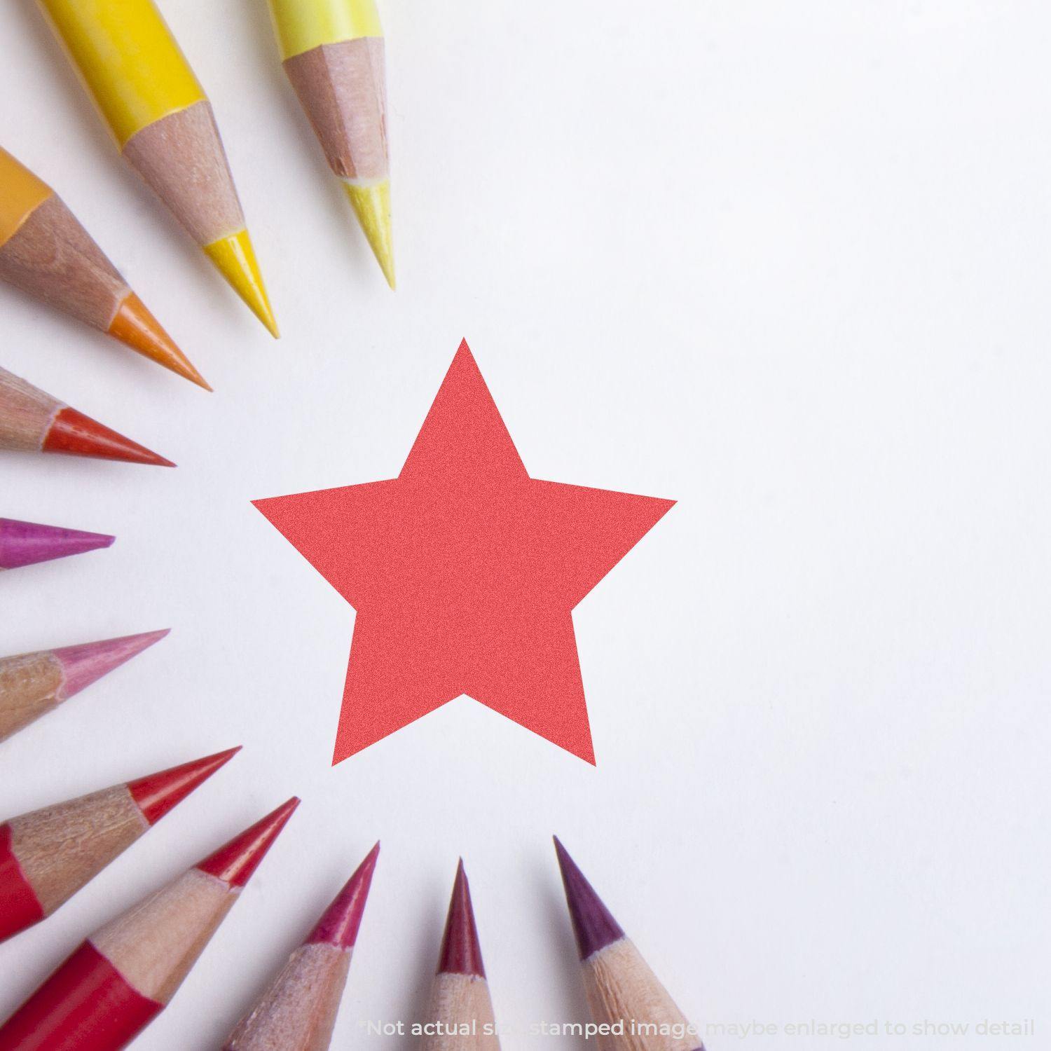 Round Red Star Xstamper Stamp imprint on white paper surrounded by colored pencils arranged in a circle.