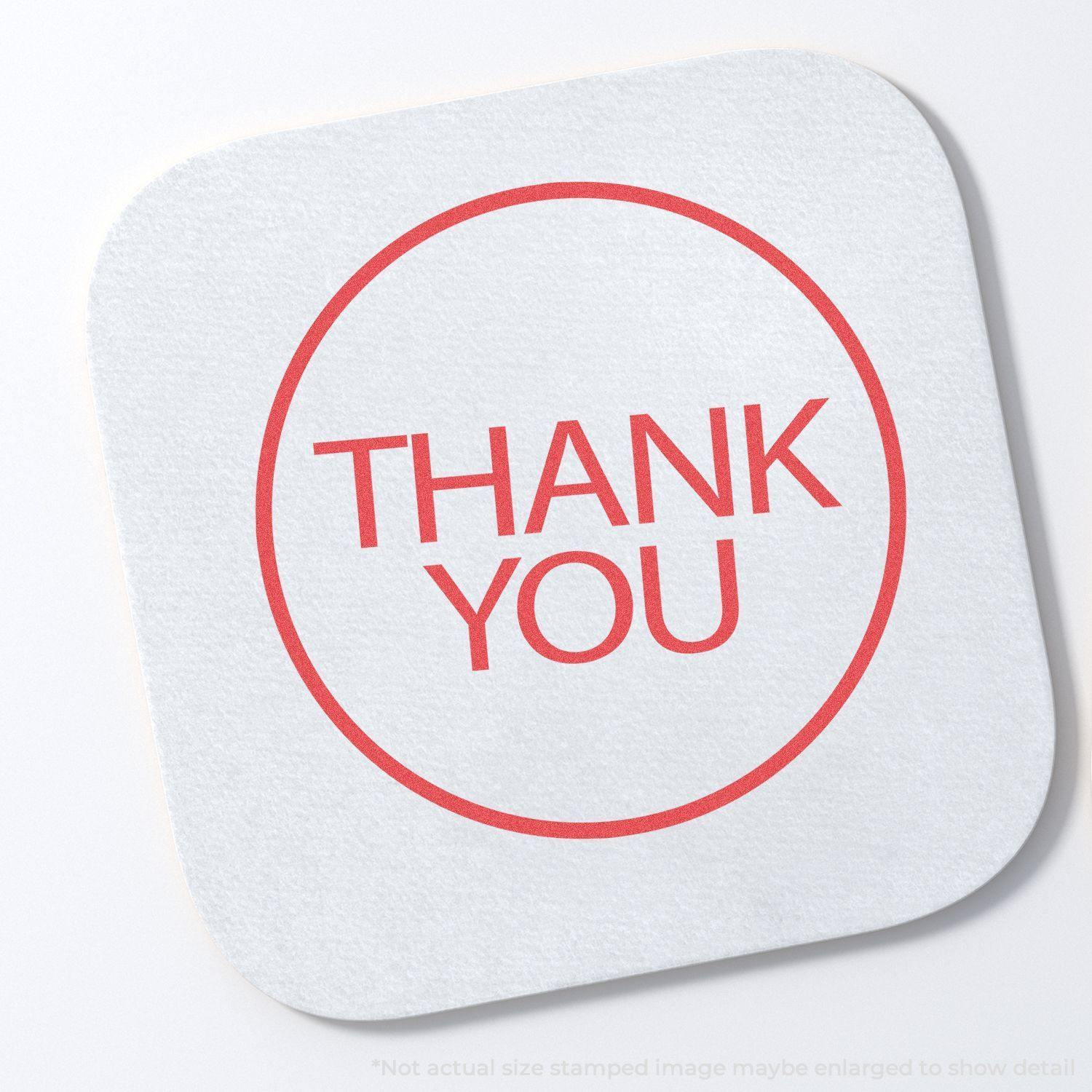Round Red Thank You Xstamper Stamp imprint on a white square paper with rounded corners, displaying THANK YOU in bold red letters.