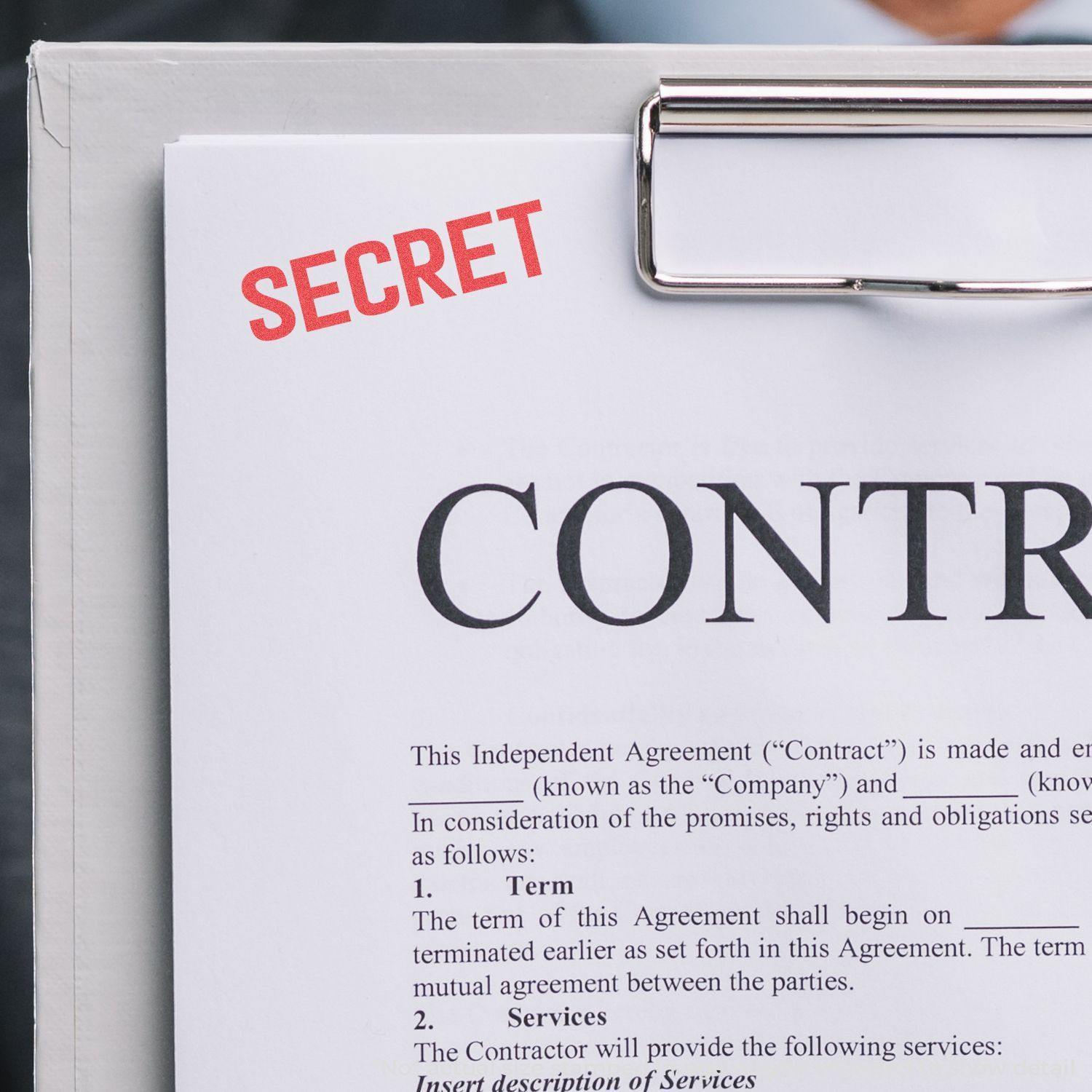A clipboard holds a contract stamped with SECRET in red using the Secret Xstamper Stamp.