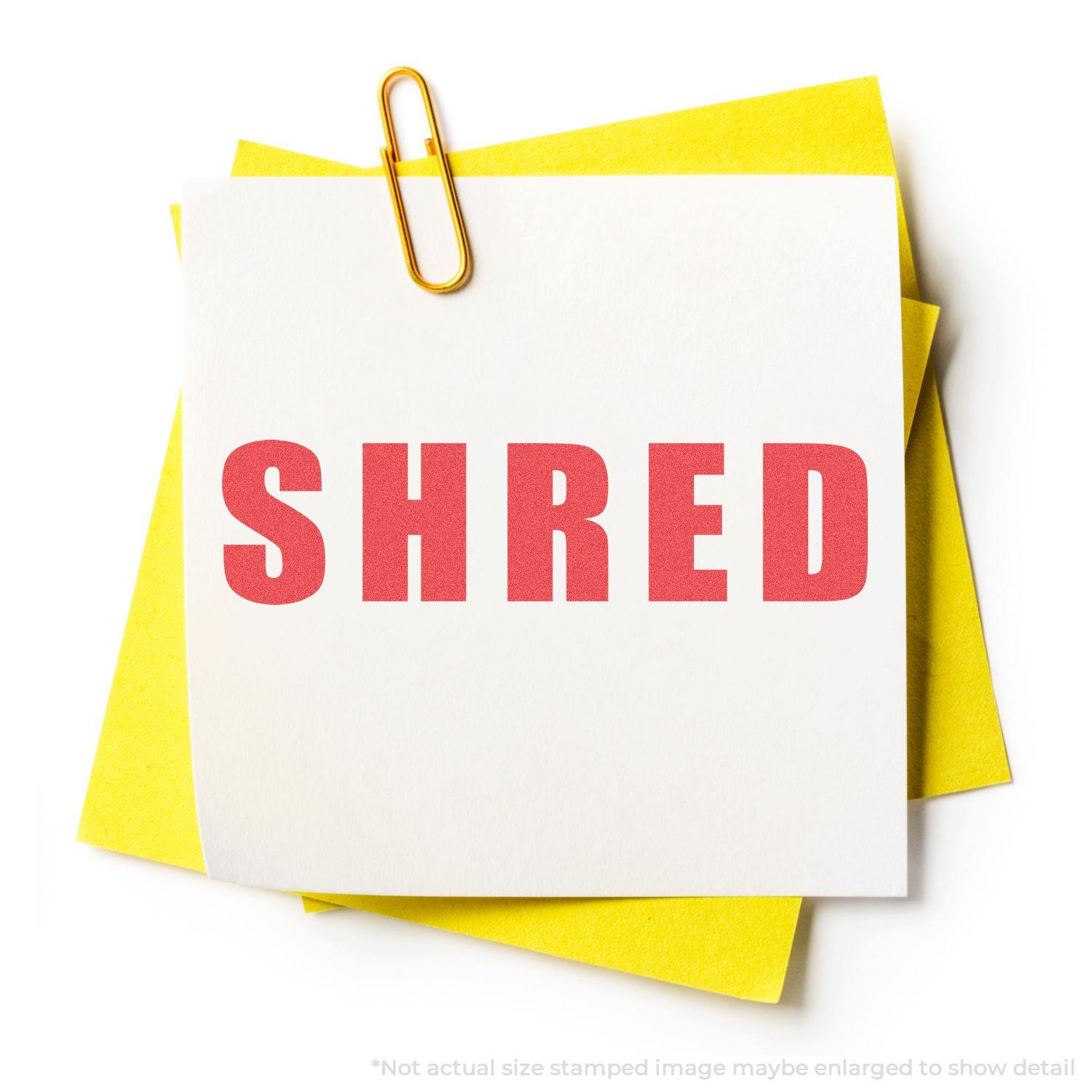 A white note stamped with SHRED in red ink using the Shred Xstamper Stamp, clipped with a paperclip to yellow papers.