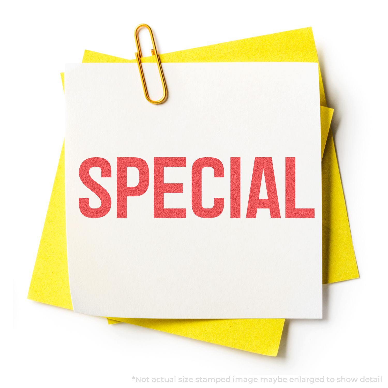 A Special Xstamper Stamp imprint on white paper with a yellow background, held by a paperclip. The word SPECIAL is stamped in red.