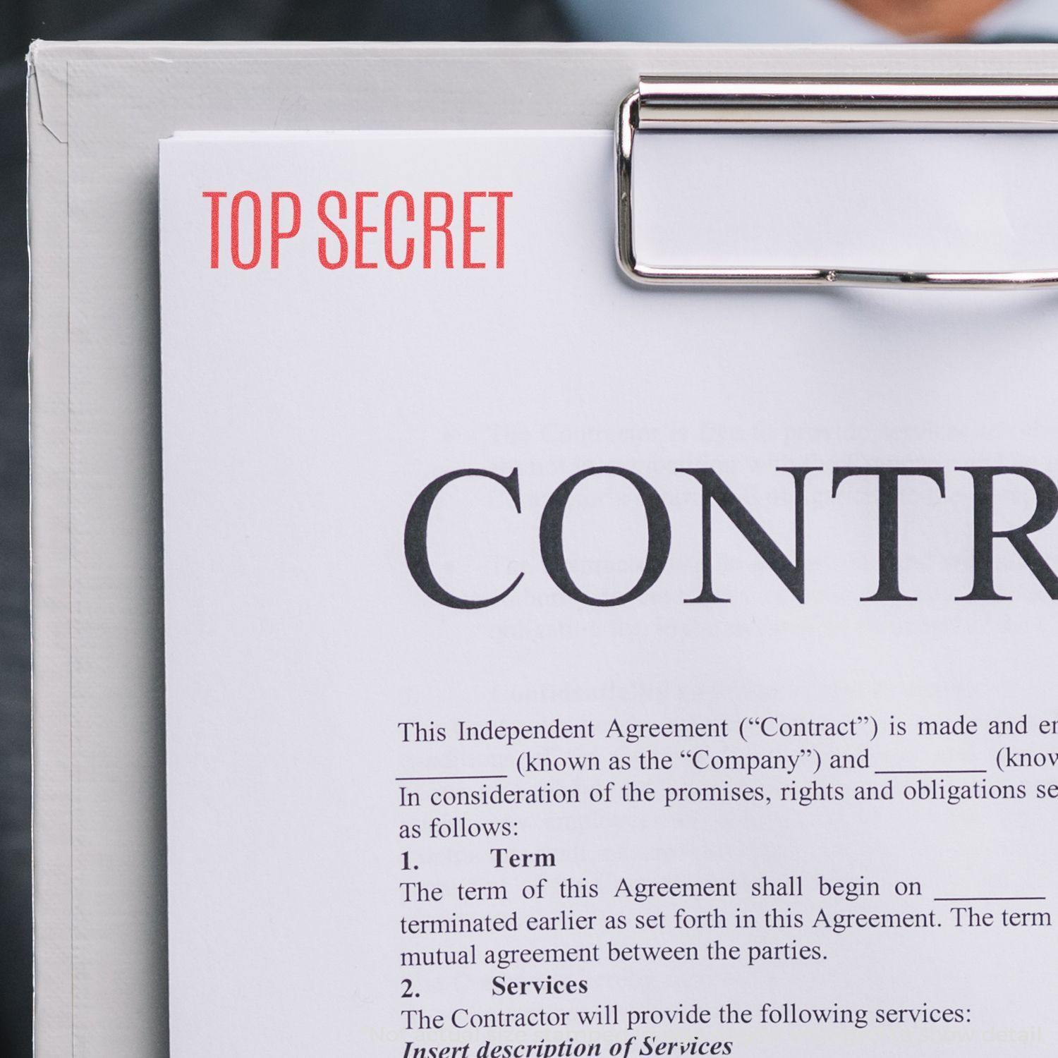 A clipboard holds a document stamped with "Top Secret" using the Top Secret Xstamper Stamp, highlighting confidentiality.