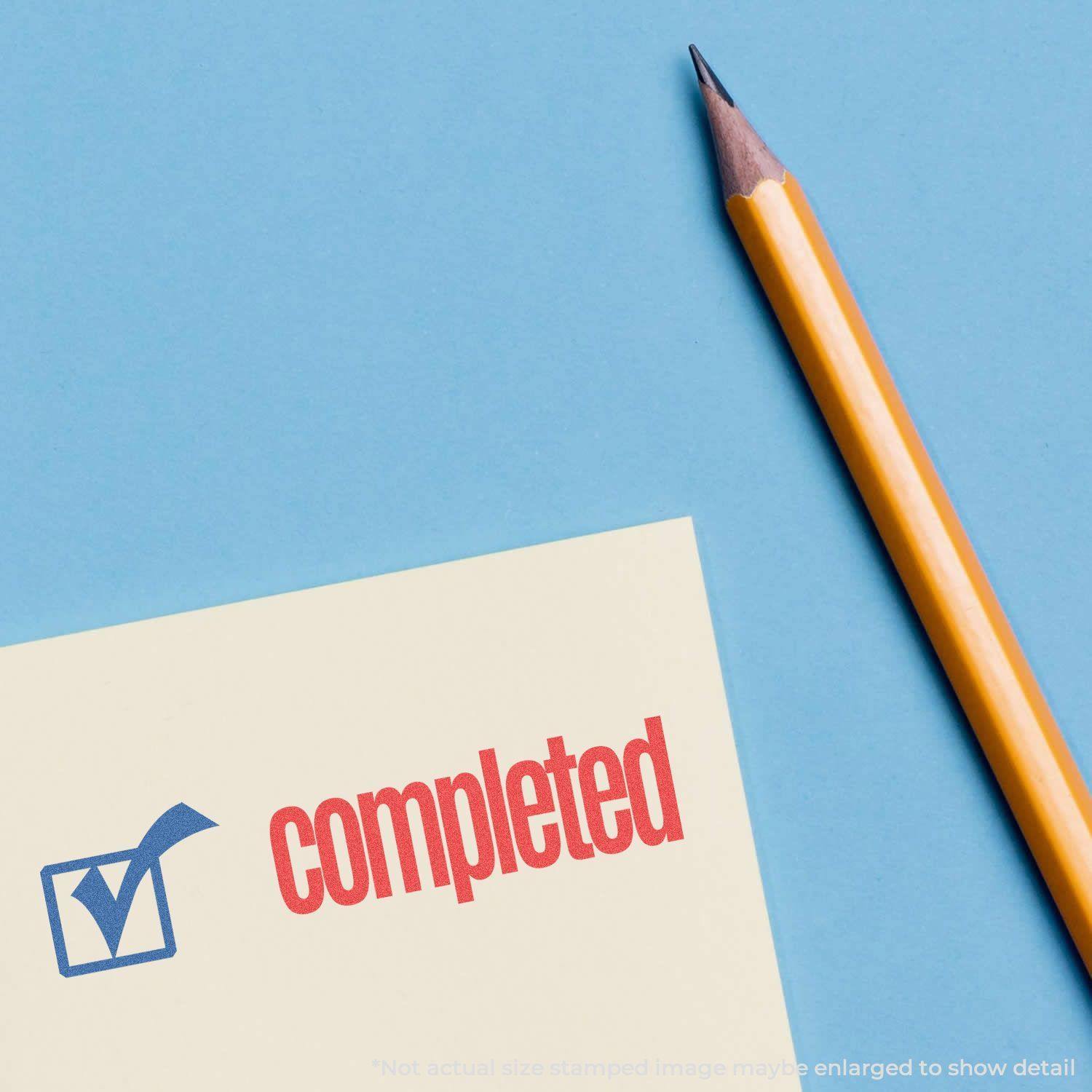 Two-Color Completed Xstamper Stamp marking a document with a blue checkmark and red completed text, next to a yellow pencil on a blue background.