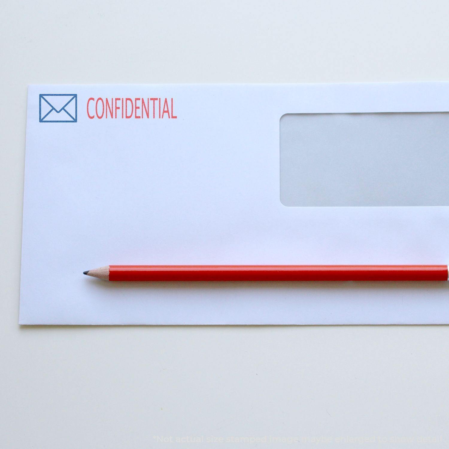 Envelope stamped with CONFIDENTIAL using the Two-Color Confidential Xstamper Stamp, with a red pencil placed on top.