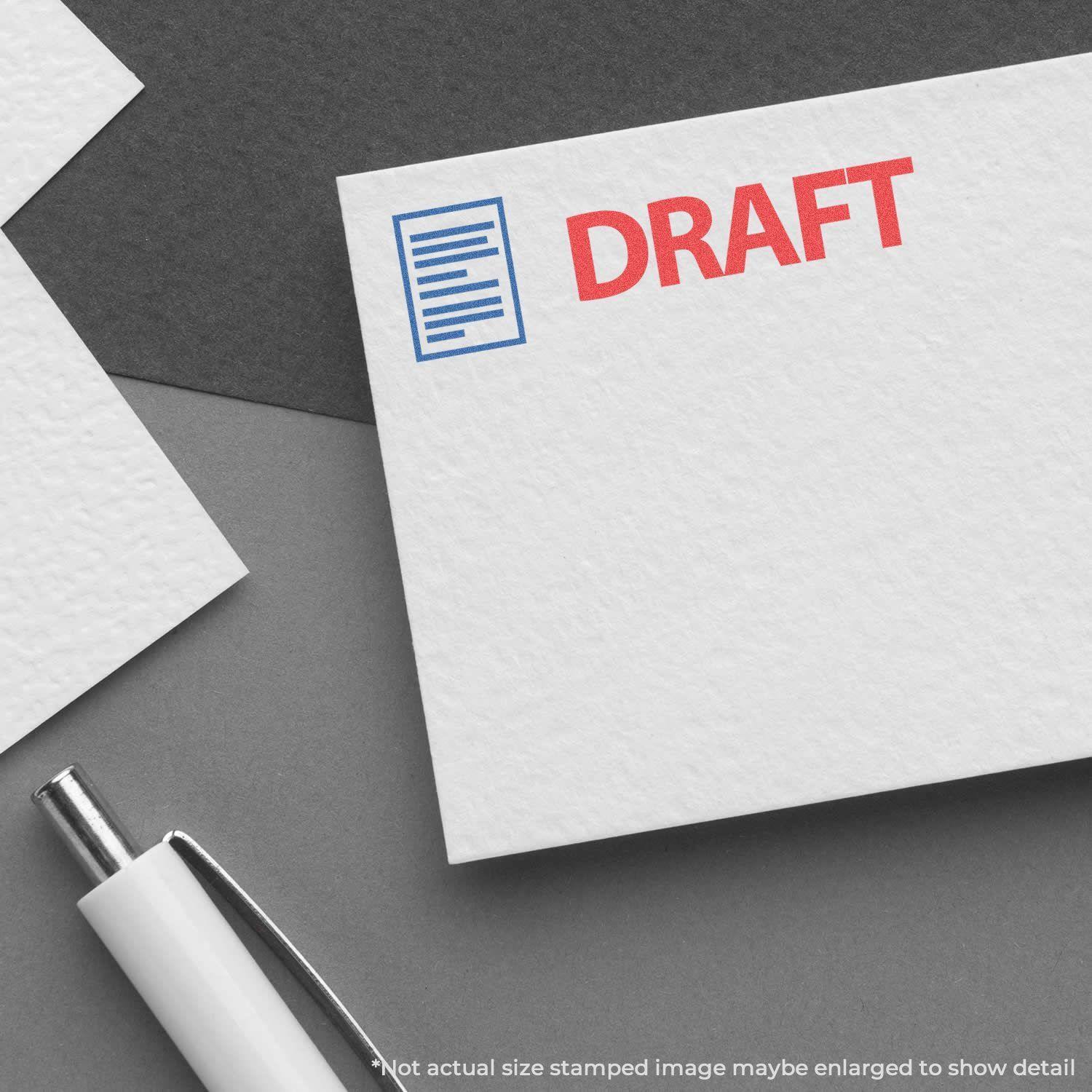 Two-Color Draft Xstamper Stamp used on white paper, showing a red DRAFT text and a blue document icon, with a pen nearby.
