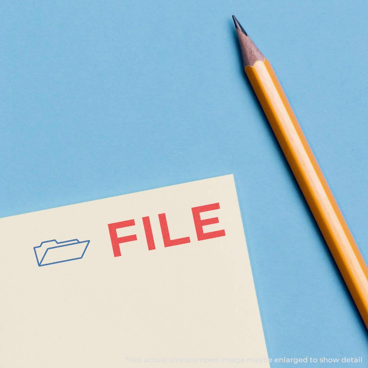 Two-Color File Xstamper Stamp marking a document with a red FILE text and a blue folder icon, next to a yellow pencil on a blue background.