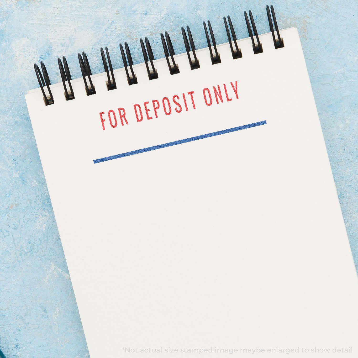 A notebook stamped with FOR DEPOSIT ONLY using the Two-Color For Deposit Only Xstamper Stamp, featuring red and blue ink.