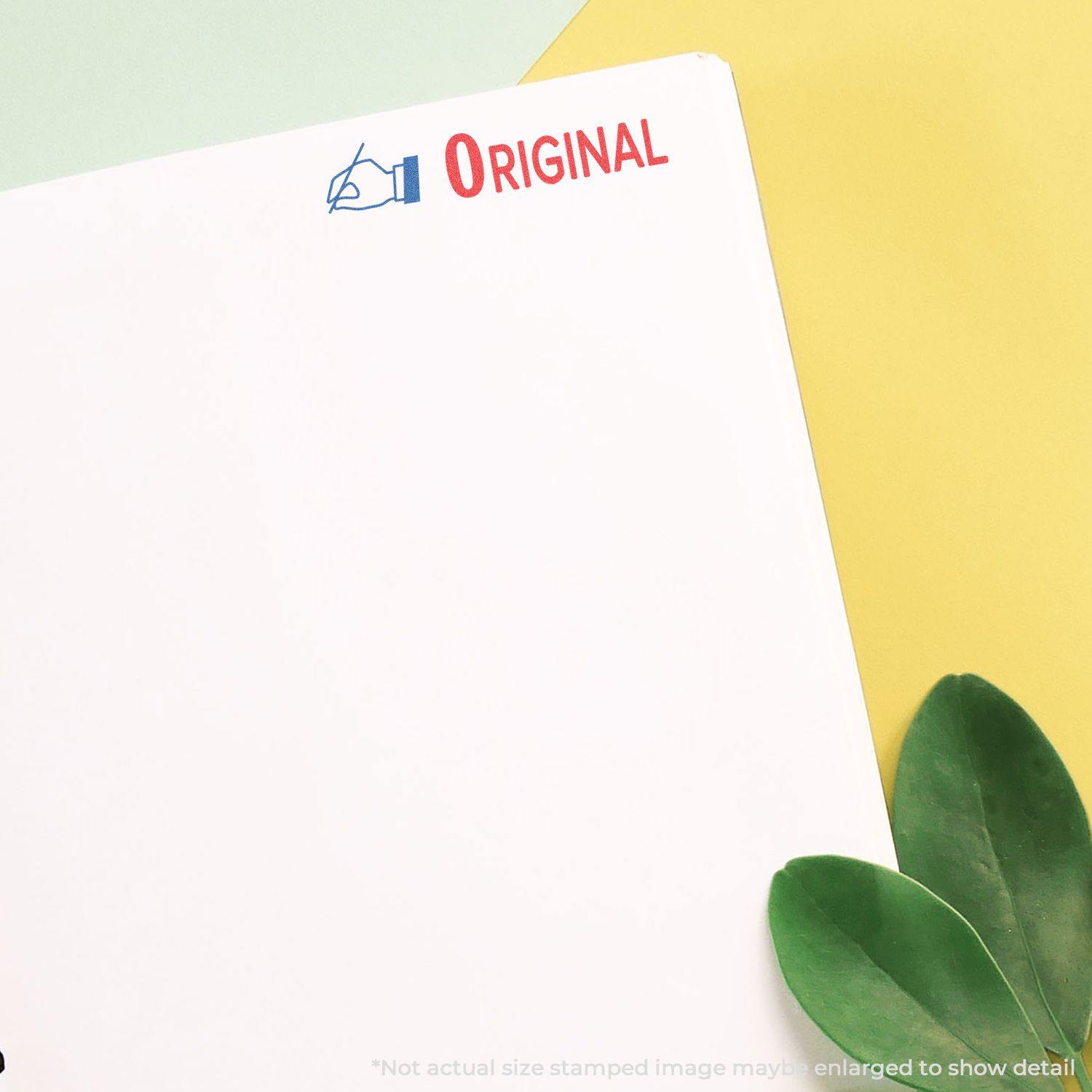 A document stamped with the Two-Color Original Xstamper Stamp showing a blue pen icon and red ORIGINAL text on a white paper.