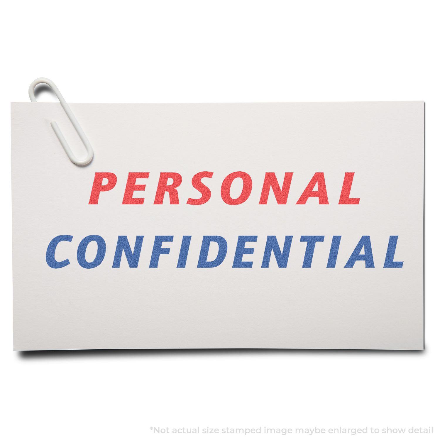 Two-Color Personal Confidential Xstamper Stamp in use, showing PERSONAL in red and CONFIDENTIAL in blue on a white card with a paperclip.