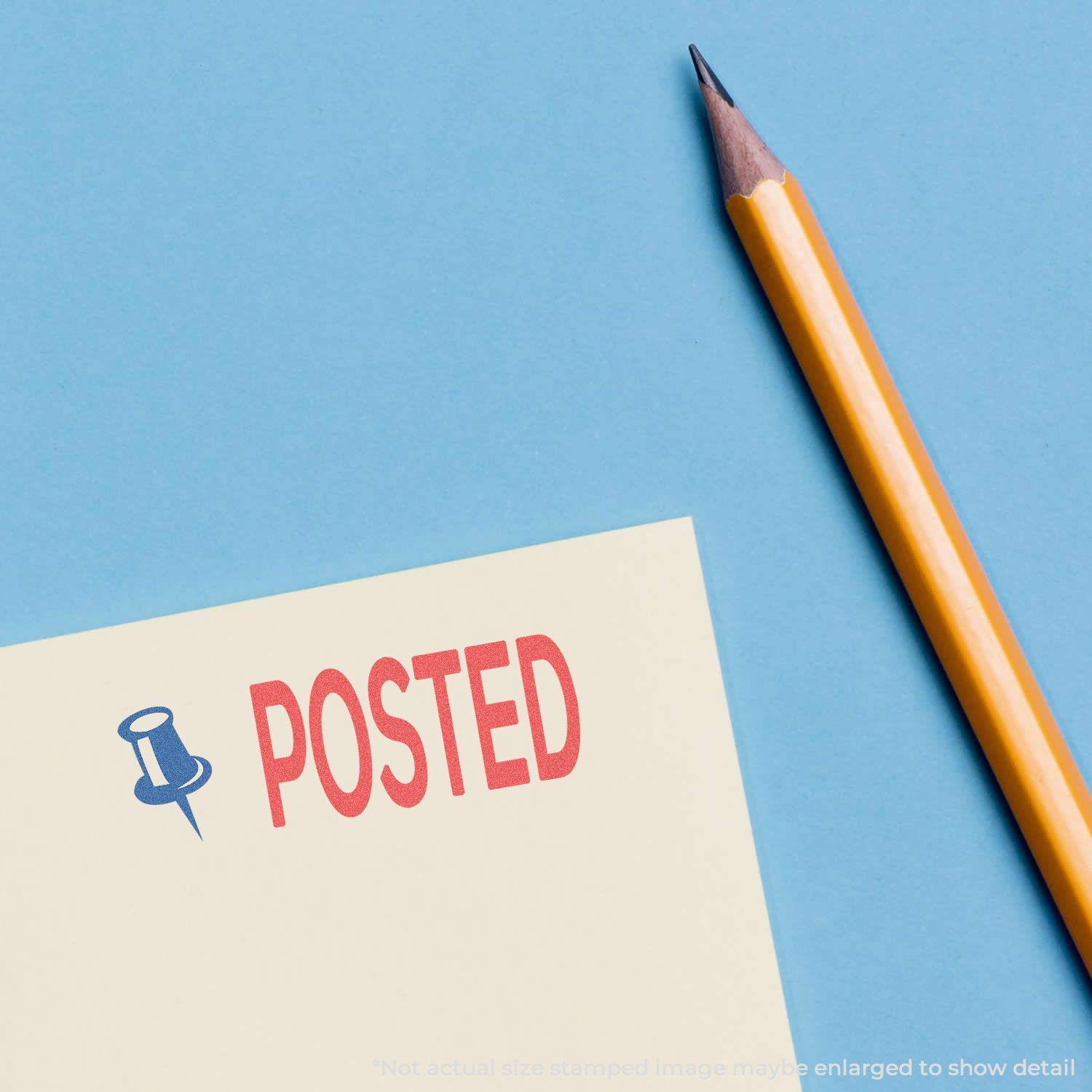 A yellow pencil next to a paper stamped with a Two-Color Posted Xstamper Stamp showing a red POSTED text and a blue pushpin icon.