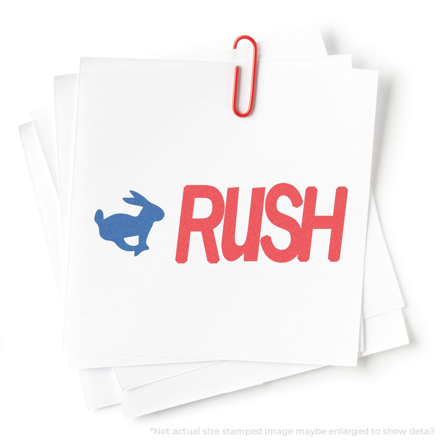 A stack of papers stamped with a blue rabbit and red RUSH using the Two-Color Rush Xstamper Stamp, held together by a red paperclip.