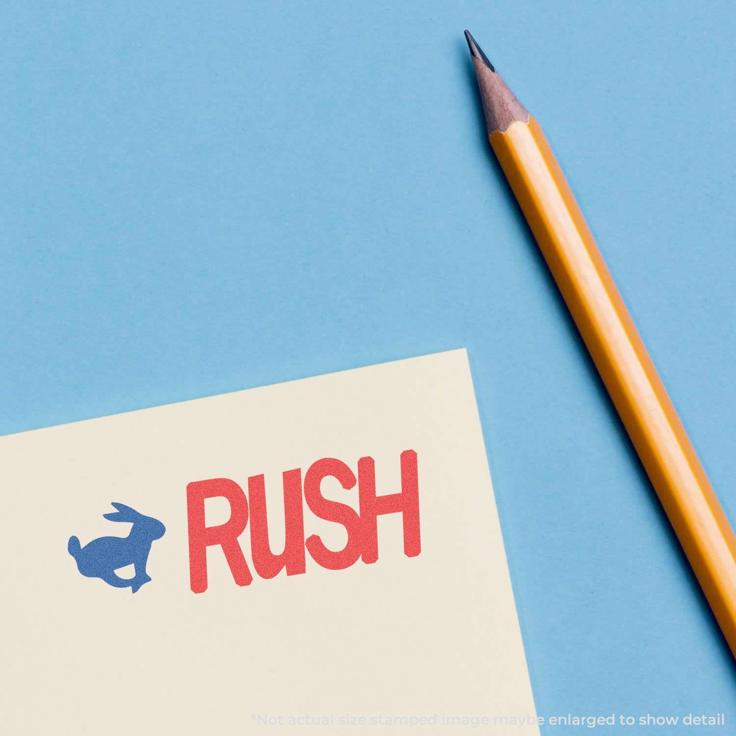 Two-Color Rush Xstamper Stamp imprint on paper with a blue rabbit icon and red RUSH text, next to a sharpened yellow pencil on a blue background.
